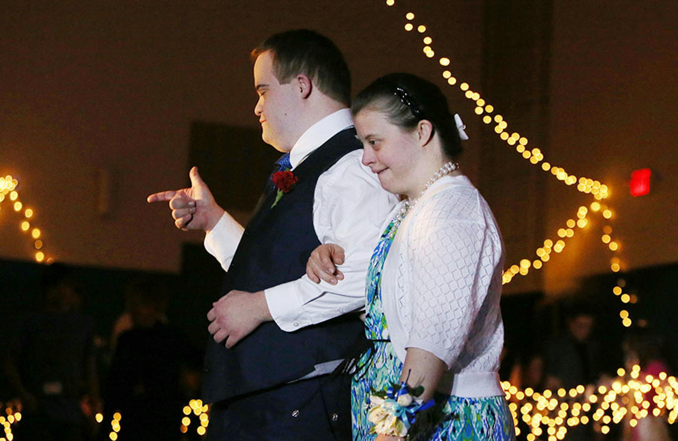 Kyle Burtman gestures while walking down the red carpet with his date Kaela Bartlett during the Snowflake Ball Saturday, Feb. 20, 2016, at Ridgewood Church in Minnetonka.