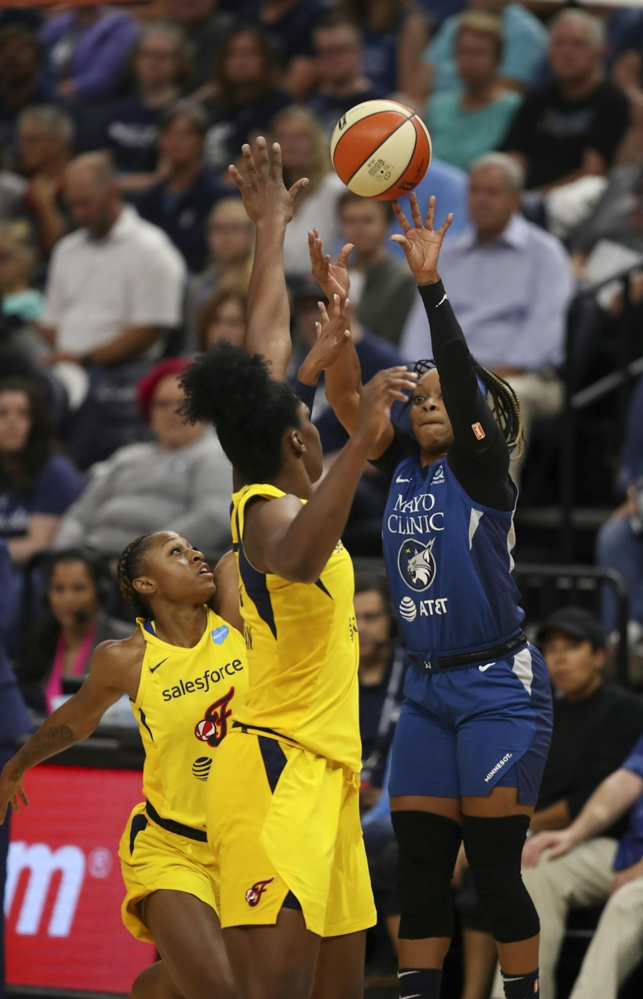 Minnesota Lynx guard Odyssey Sims took a first quarter shot over Indiana Fever guard Tiffany Mitchell, left, and Indiana Fever center Teaira McCowan.
