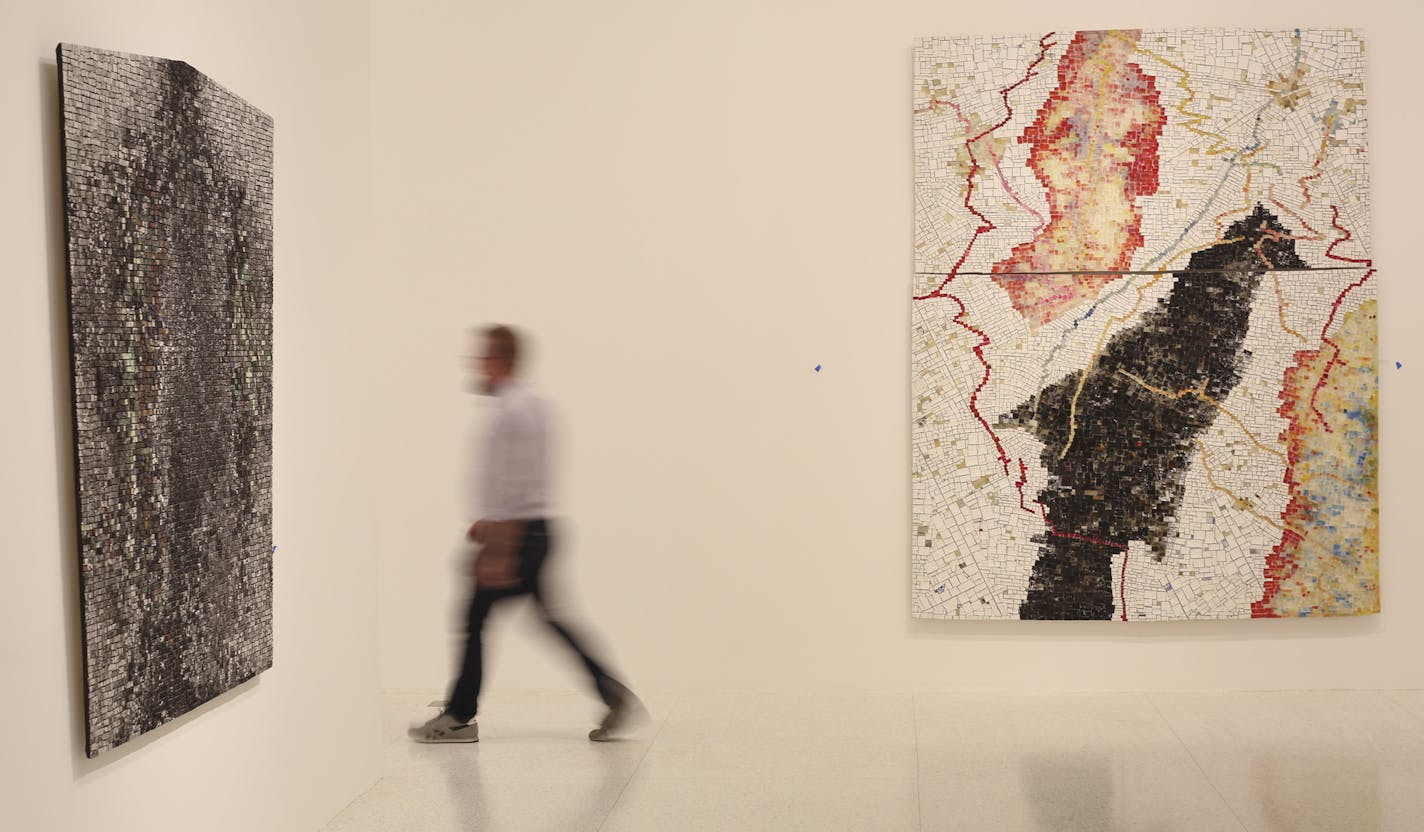 Walker curator Eric Crosby with the 1998 Jack Whitten painting "Black Monolith III (For Barbara Jordan)," left, and the 1998 work "Flying High: Betty Carter."