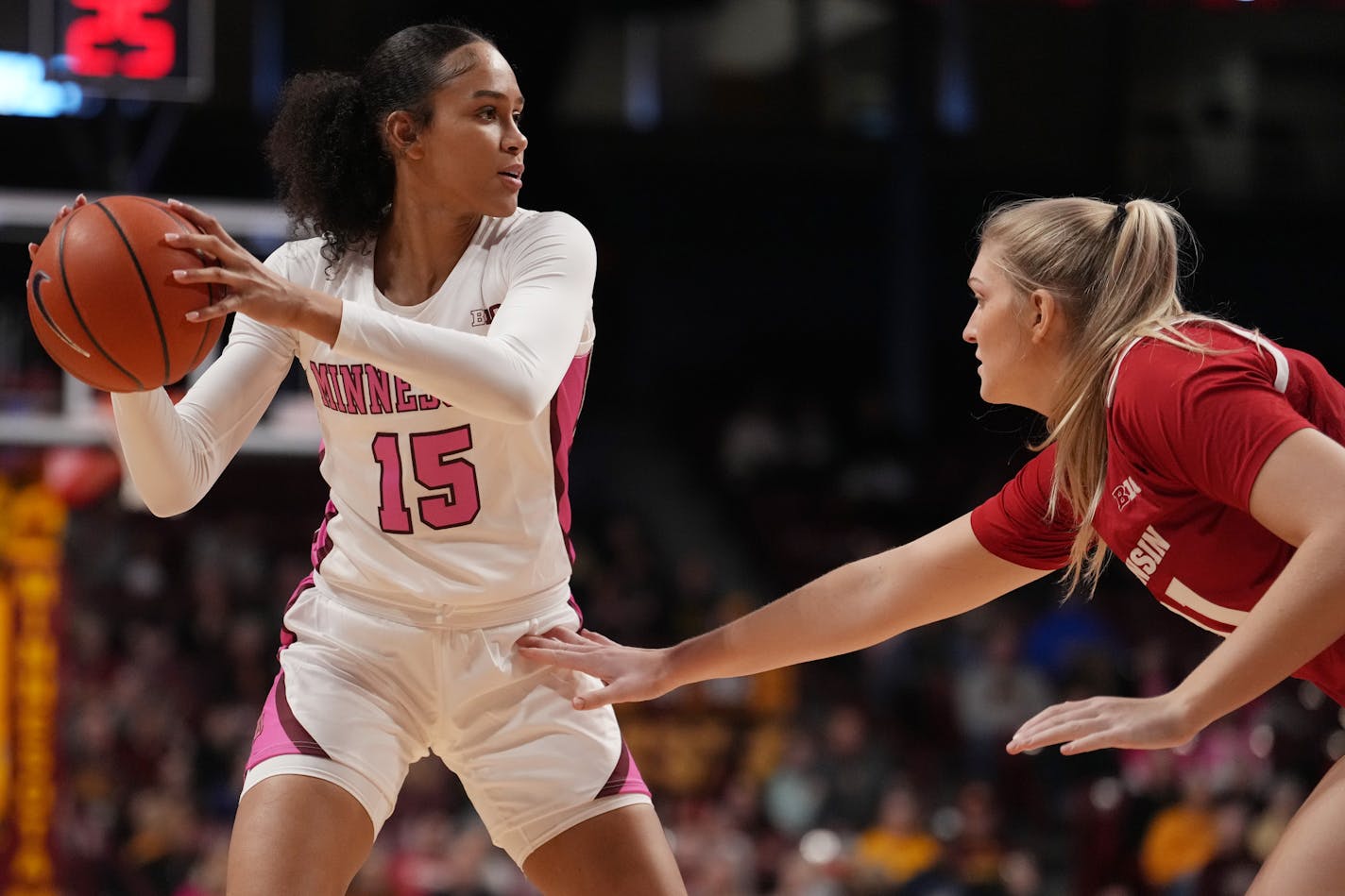 Minnesota Gophers guard Angelina Hammond (15) searches for an open teammate as Wisconsin Badgers center Sara Stapleton (41) defends in the first half of an NCAA women's basketball game between the Minnesota Gophers and the Wisconsin Badgers Saturday, Feb. 11, 2023 at Williams Arena in Minneapolis. ] ANTHONY SOUFFLE • anthony.souffle@startribune.com