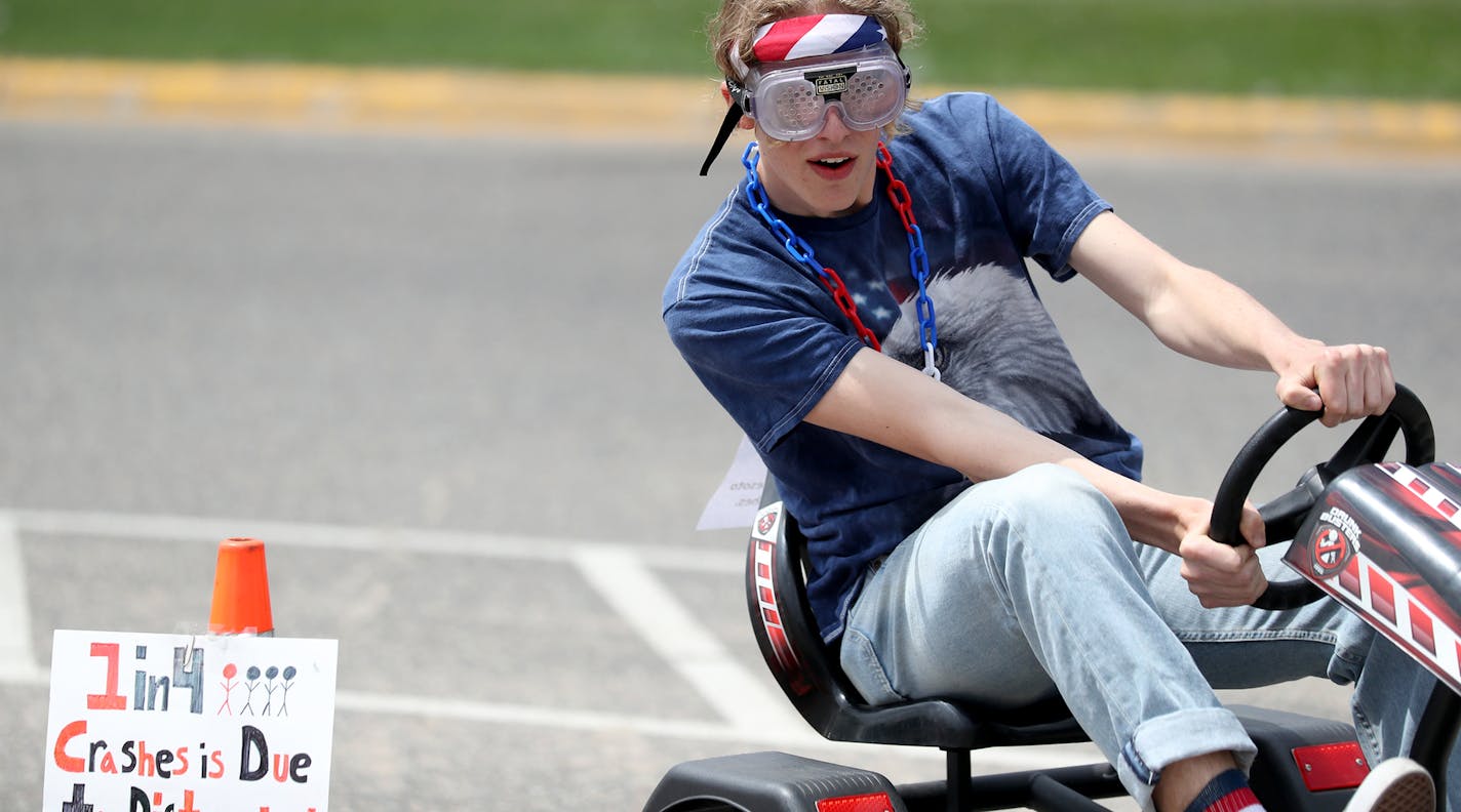 John Botteli, a junior at Woodbury High School, tries to navigate obstacles while wearing impairment simulation goggles Tuesday, May 22, 2018.