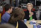 In this April 14, 2015, photo, Democratic presidential candidate Hillary Rodham Clinton, right, participates in a roundtable with educators and studen