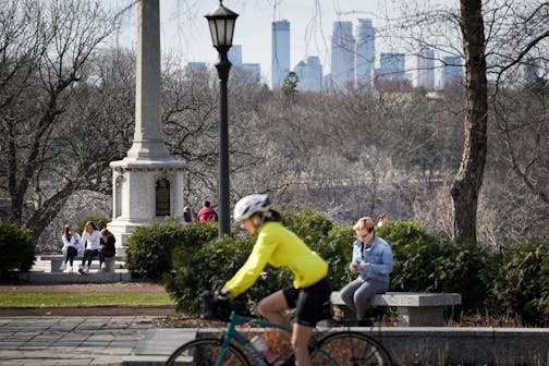 Bikers, joggers and pedestrians struggled to keep their distance as they enjoyed the sun and warm temperatures near the Monument on the west end of Summit Avenue along Mississippi River Boulevard in St. Paul on Sunday, April 5.