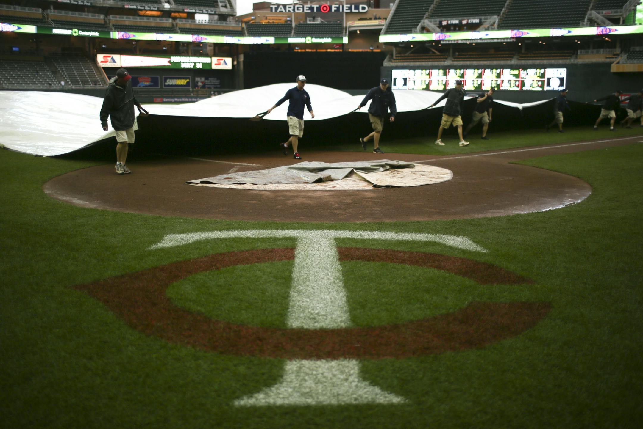 The Twins faced the Boston Red Sox on May 19, 2013 at Target Field. The grounds crew removed the tarp off the field after rain let up and the game could resume that evening.