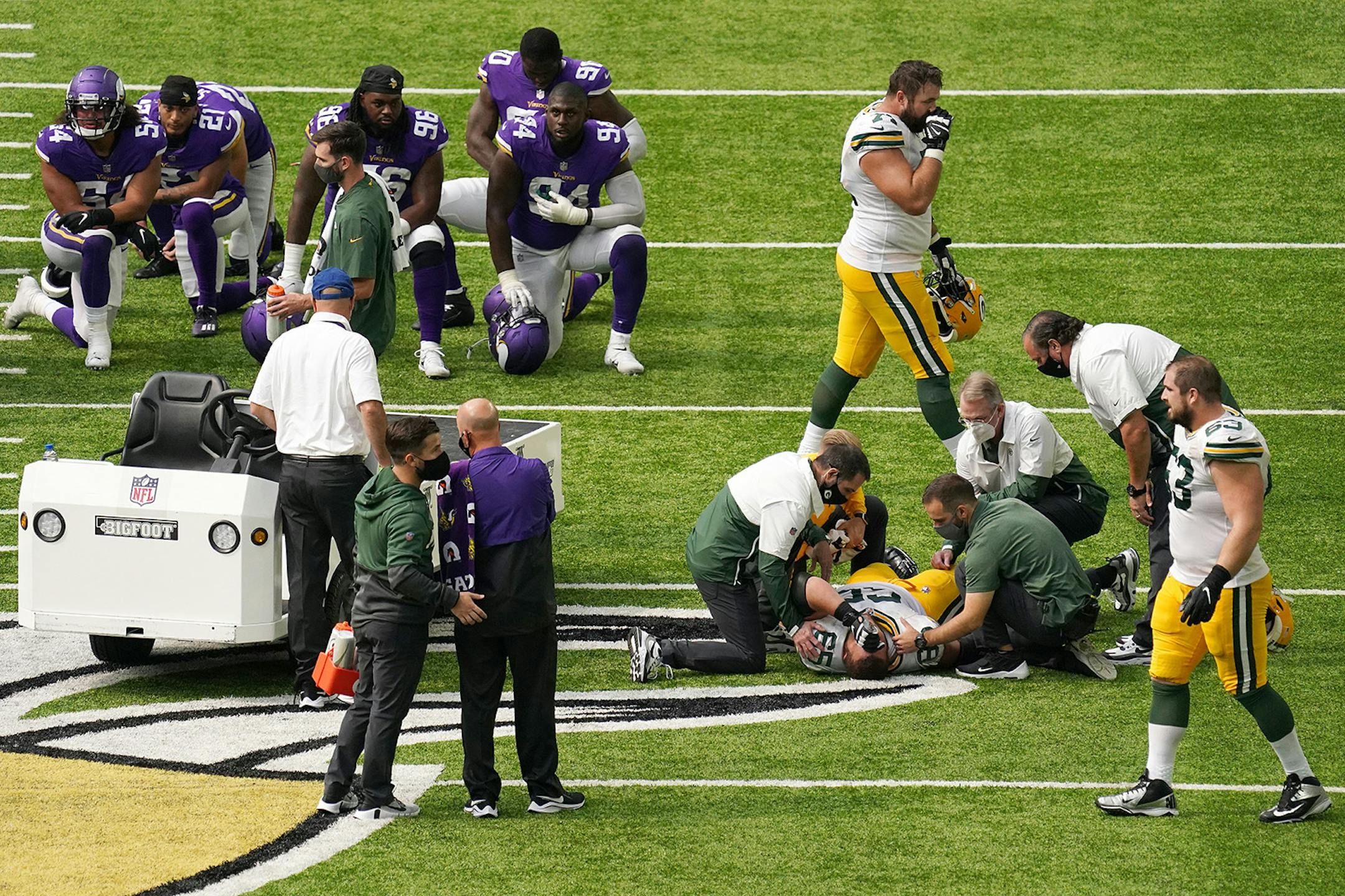 Green Bay Packers offensive guard Lane Taylor (65) was helped on the field after going down with an injury in the fourth quarter.