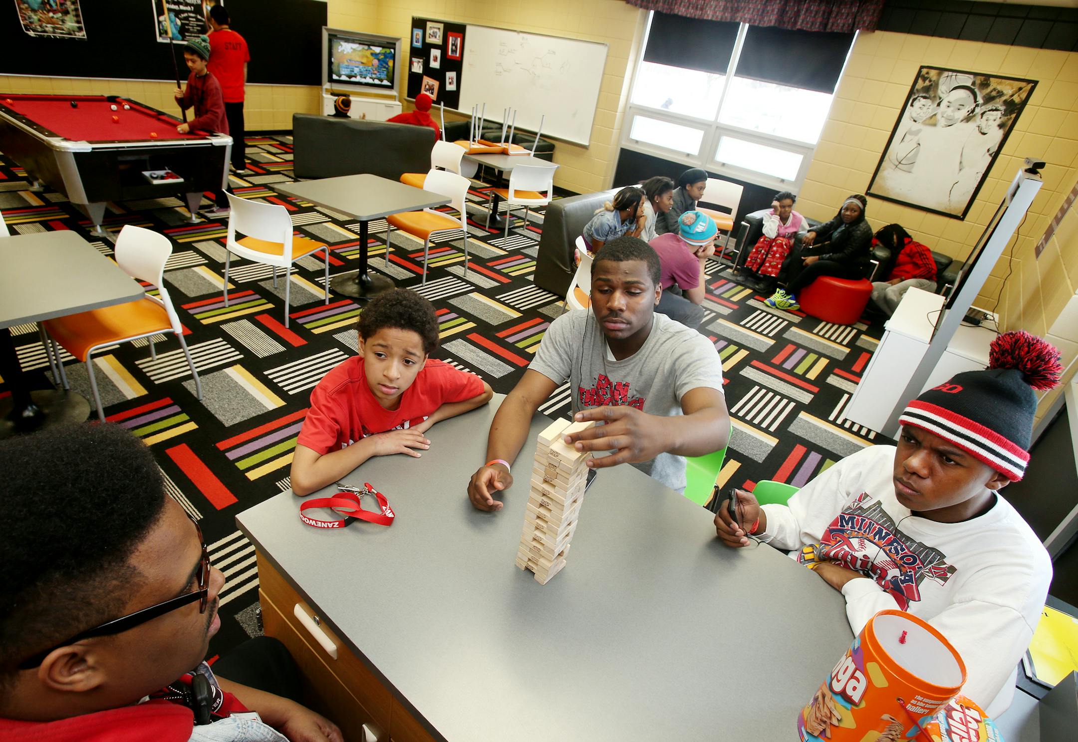 Youth leader Brandon Nelson (bottom left) plays Jenga with teenagers AJ Price (red shirt), Brandon Blundt (gray t-shirt), and William Shields (right) at Zanewood Recreation Center. ] JOELKOYAMA‚Ä¢jkoyama@startribune Brooklyn Park, MN on February 13, 2014. Youth violent crime has dropped in Brooklyn Park and police think offering a bevy of activities after school at Zanewood Recreation Center has a lot to do with the drop. The city's efforts in the past several years have been no