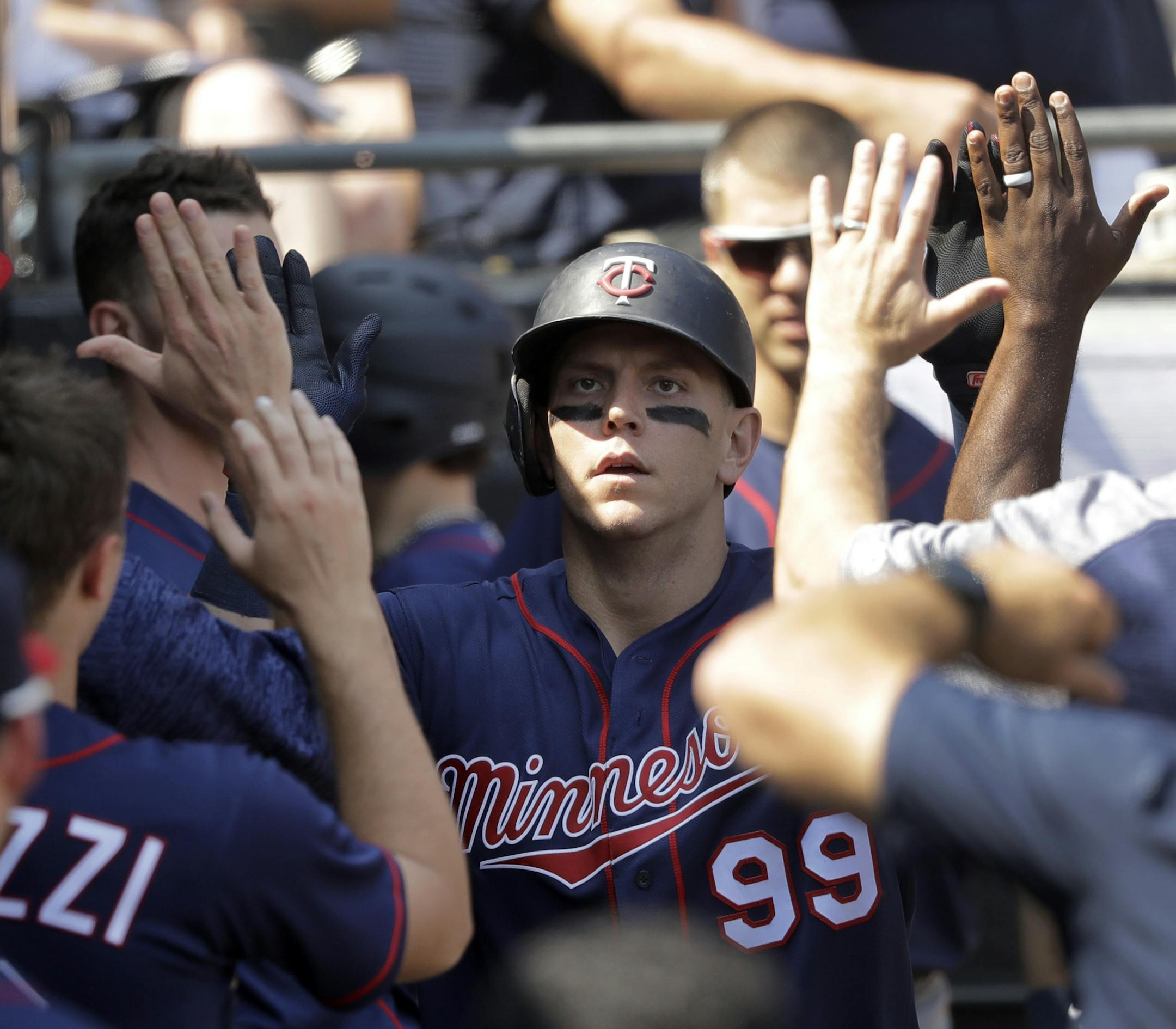 Minnesota Twins' Logan Morrison celebrates his home run off Chicago White Sox starting pitcher Lucas Giolito, in the dugout during the seventh inning of a baseball game Thursday, June 28, 2018, in Chicago. (AP Photo/Charles Rex Arbogast)