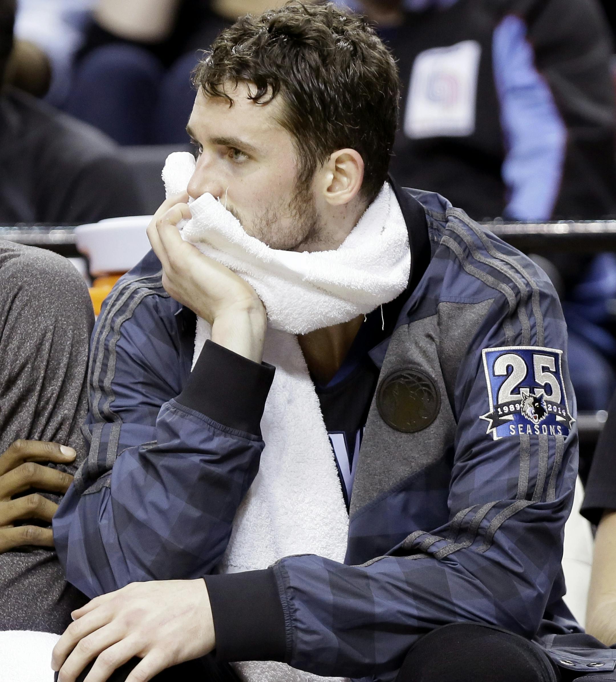 Minnesota Timberwolves forward Kevin Love sits on the bench late in the second half of an NBA basketball game against the Portland Trail Blazers in Portland, Ore., Saturday, Jan. 25, 2014. Portland won 115-104.(AP Photo/Don Ryan)