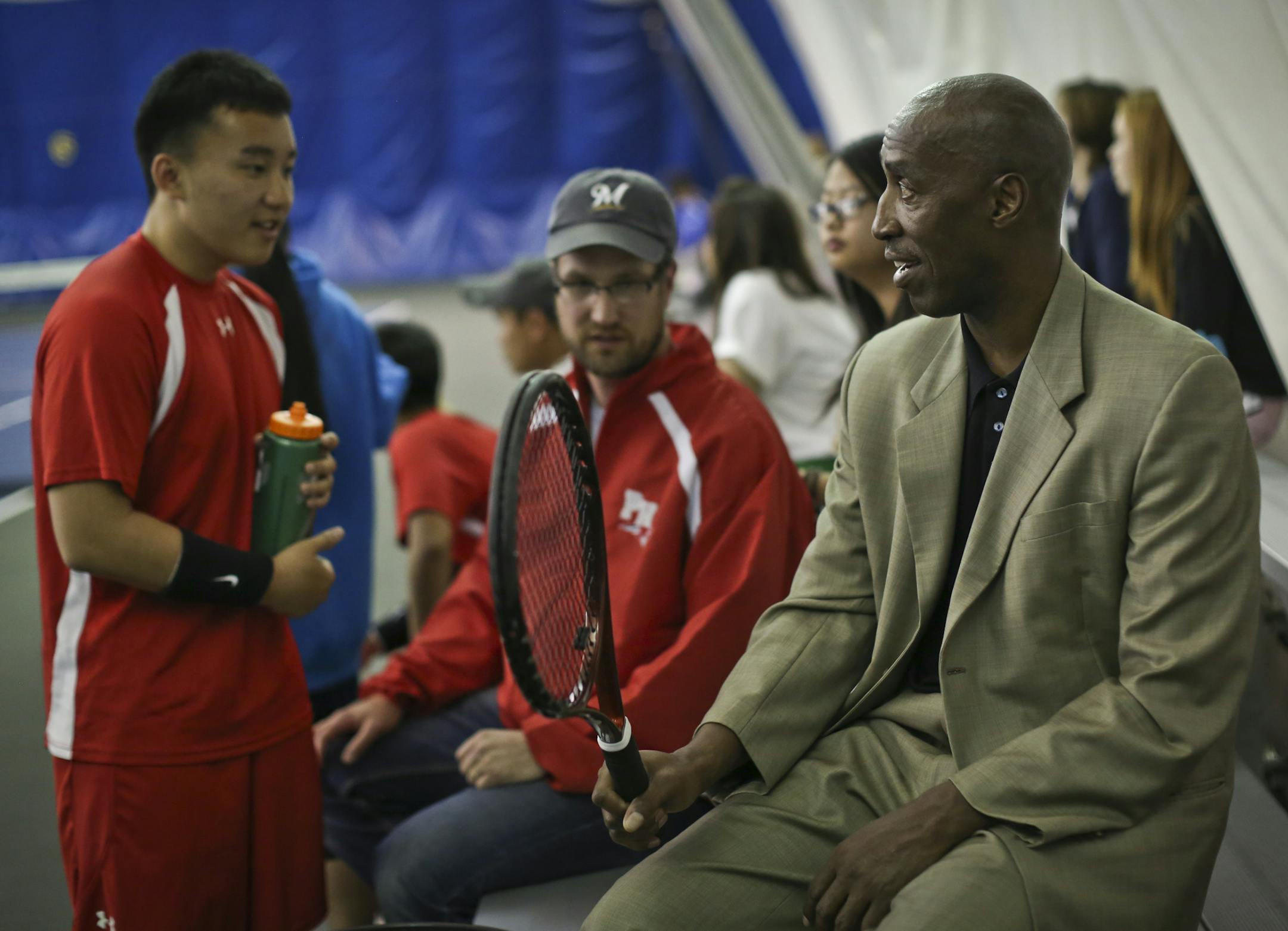 New Minneapolis Public Schools athletic director Trent Tucker chatted with Henry first doubles player Chee Meng Yang, left, and his coach, Paul Czarnezki.