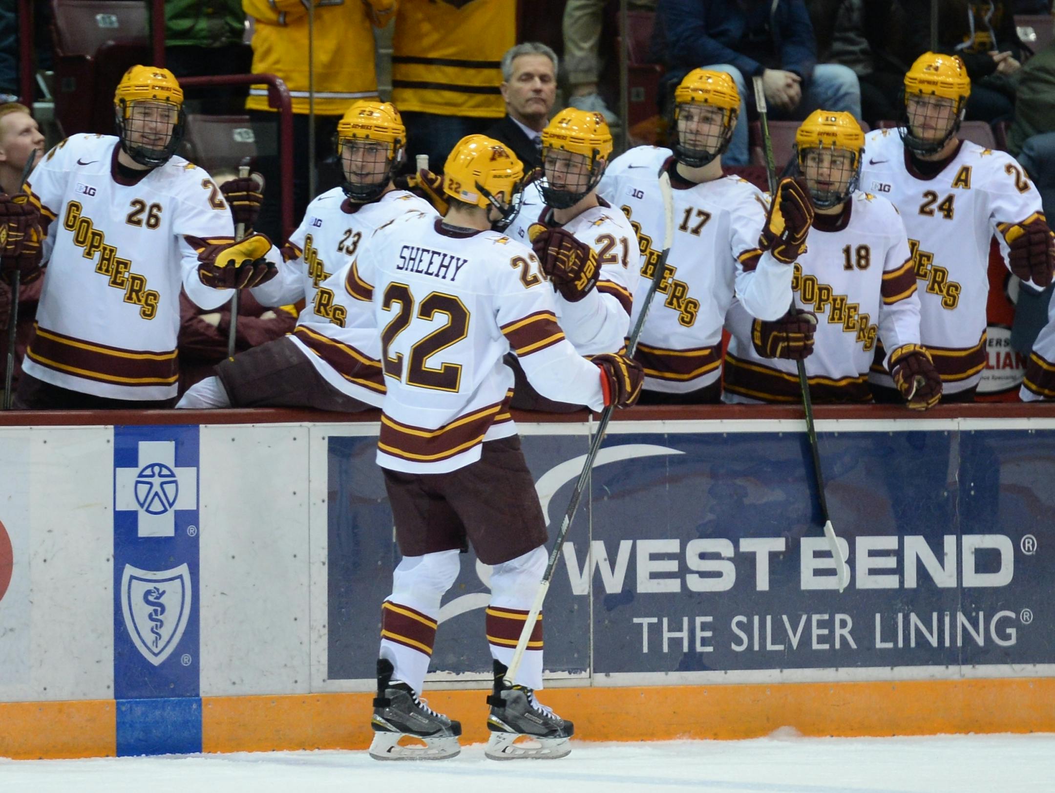 Minnesota Golden Gophers right wing Tyler Sheehy (22) high fived teammates after scoring a goal against the Penn State Nittany Lions in the second period.