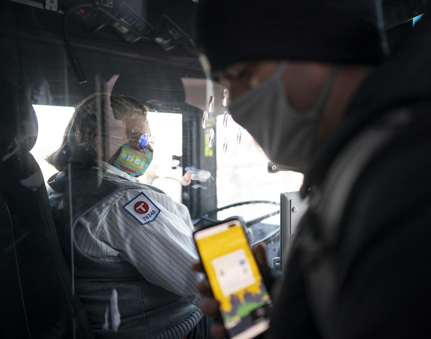 A masked passenger flashed his pass to MTC bus driver Jean Mier upon boarding her route 94 bus Wednesday afternoon in Minneapolis. ] JEFF WHEELER • jeff.wheeler@startribune.com MTC bus driver Jean Mier didn't have to tell anyone to put a mask on while driving her first round trip of the 94 bus between Minneapolis and St. Paul Wednesday afternoon, November 11, 2020.