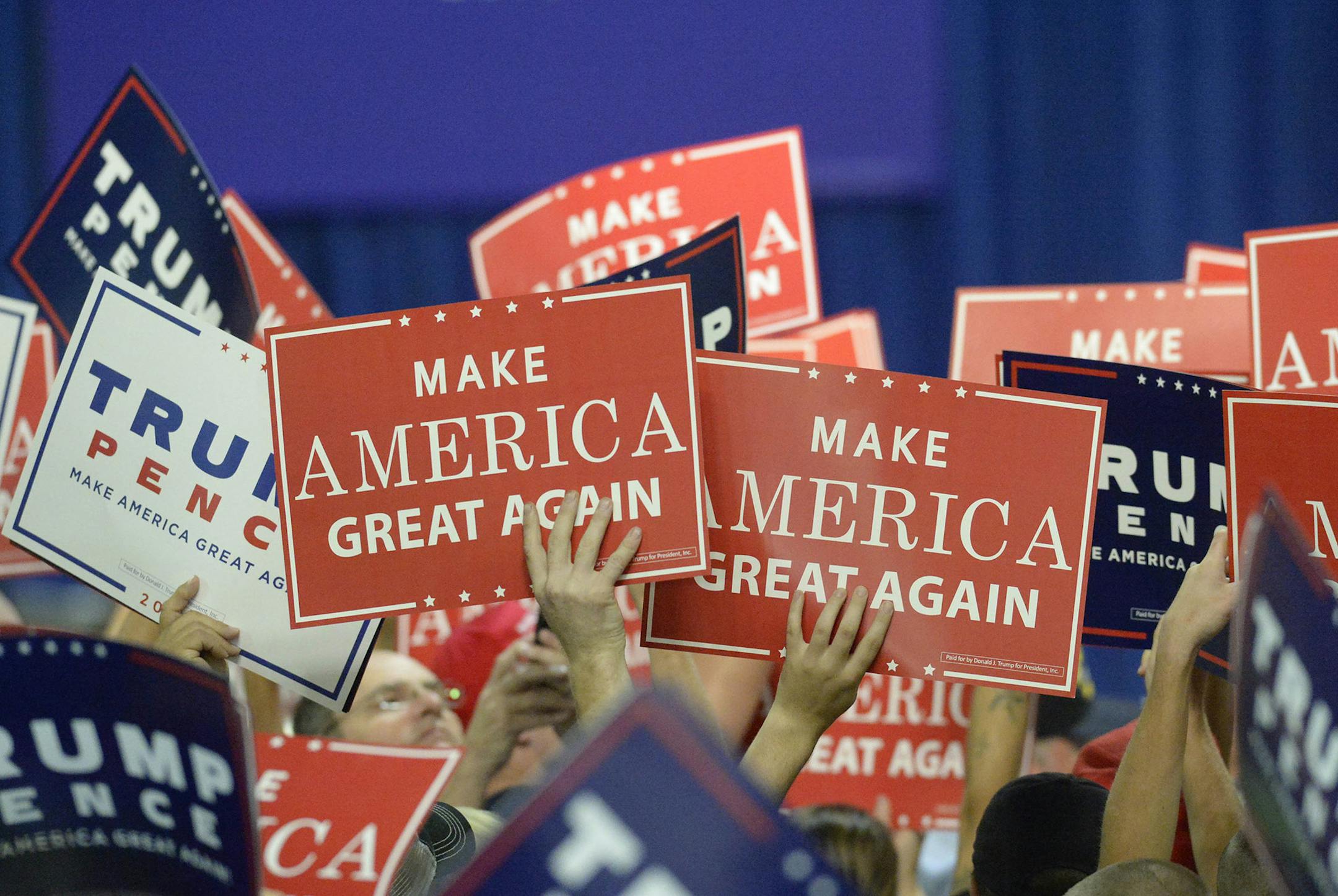 Supporters of Republican presidential candidate Donald Trump wave signs during a campaign rally at the Charlotte Convention Center in Charlotte, N.C., on Friday, Oct. 14, 2016. (David T. Foster III/Charlotte Observer/TNS) ORG XMIT: 1191709 ORG XMIT: MIN1610142053220691