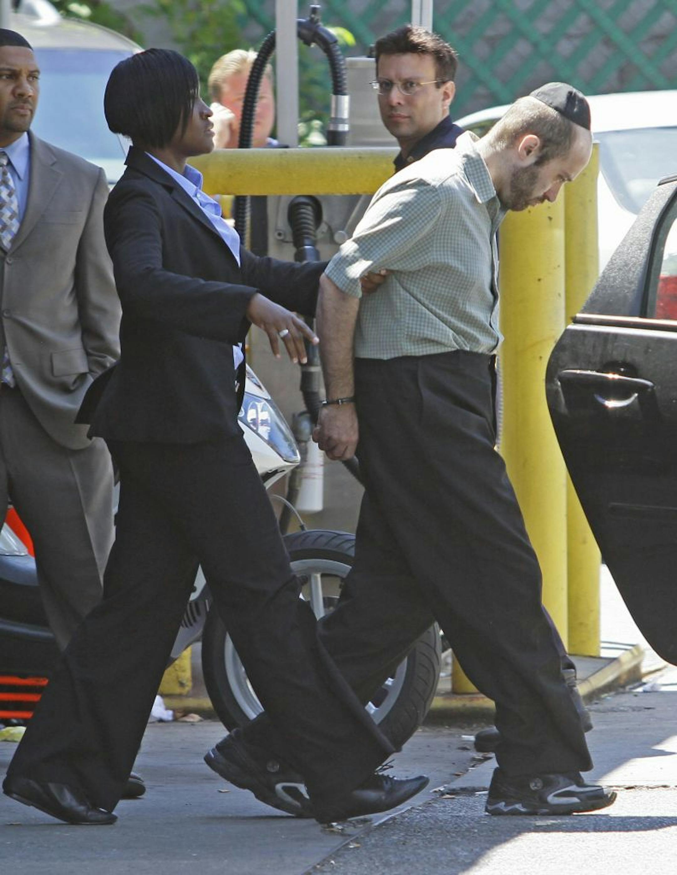 A detective walked Levi Aron to a police car at New York City's 67th precinct on Thursday. Aron is accused of killing 8-year-old Leiby Kletzky, who disappeared while walking home from a Brooklyn day camp.