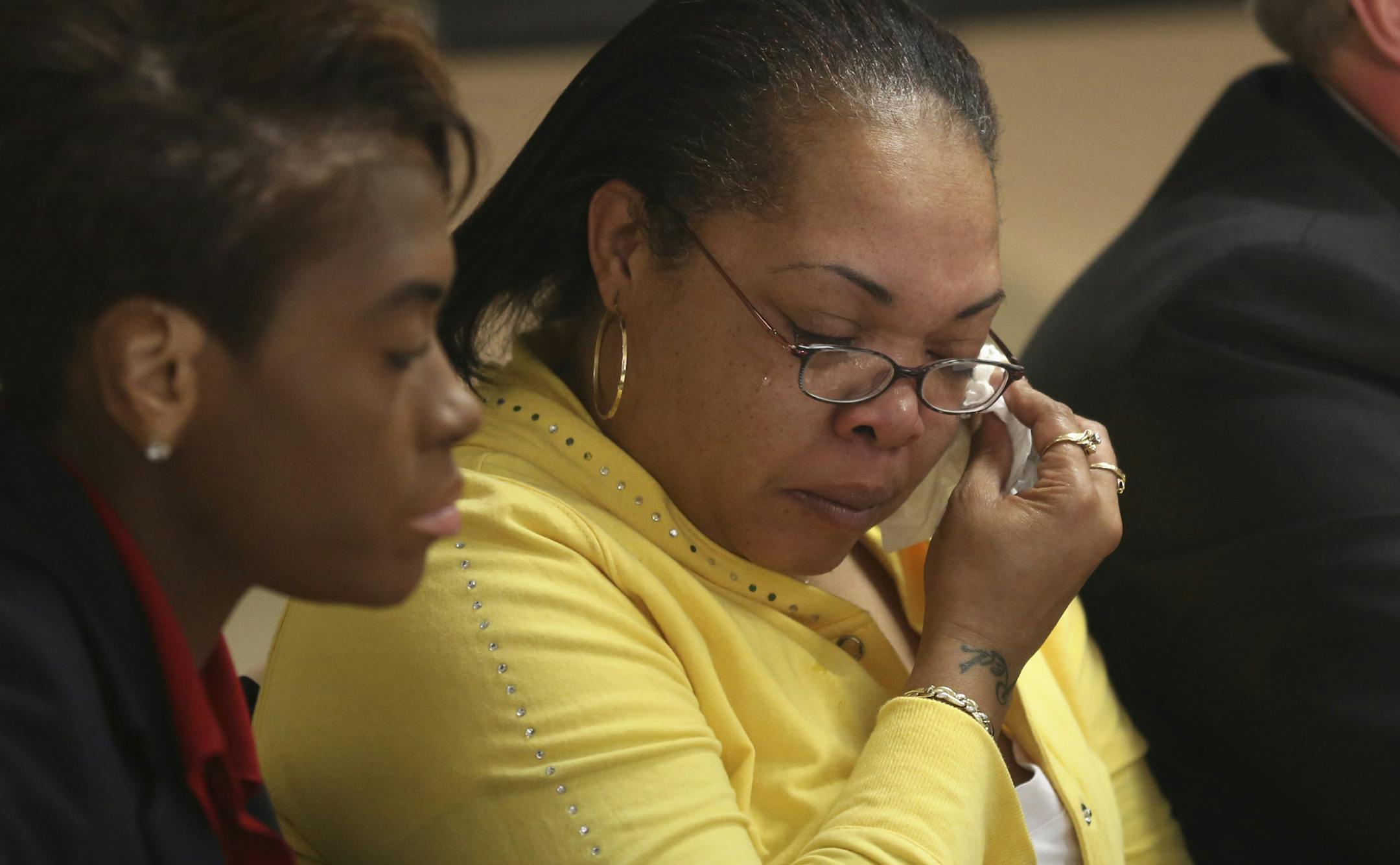 With Karlowba Adams Powell, of Padden & McCollister, on the left, Sheila O'Neal , mother of Terrance Franklin, who was shot and killed by police wiped tears away as the family's lawyerMichael Padden addressed the media during a press conference at the a Min., Thursday, May 30, 2013. ] (KYNDELL HARKNESS/STAR TRIBUNE) kyndell.harkness@startribune.com