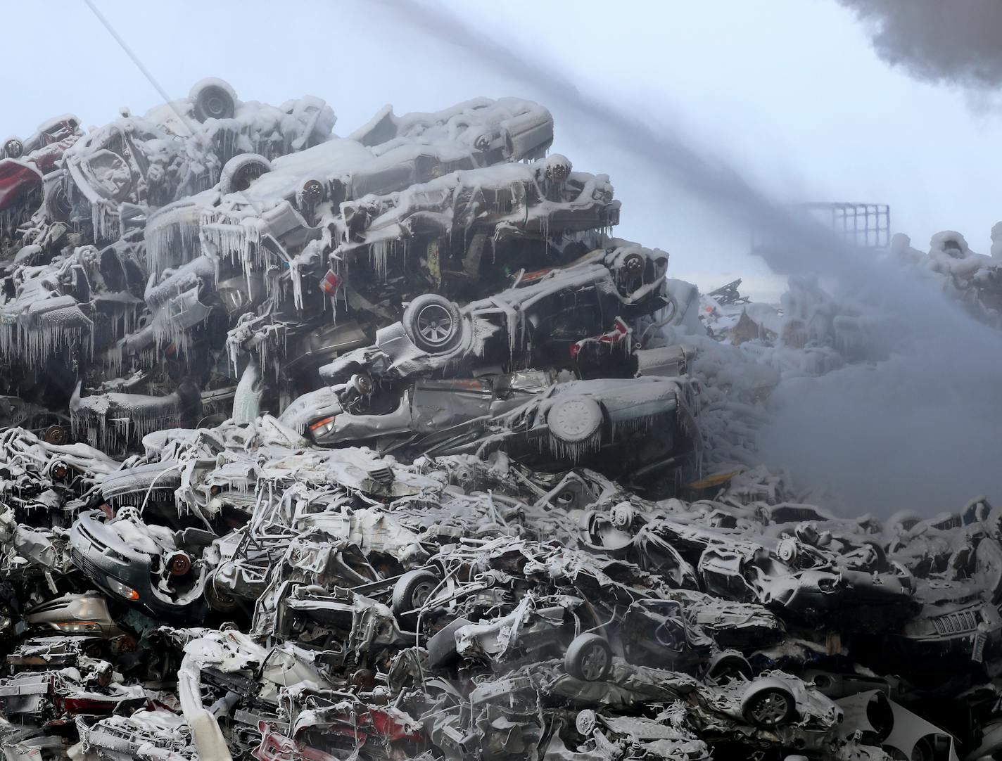 Junked autos at Northern Metal Recycling in Becker, Minn., were encased in ice from firefighters' efforts Wednesday morning.