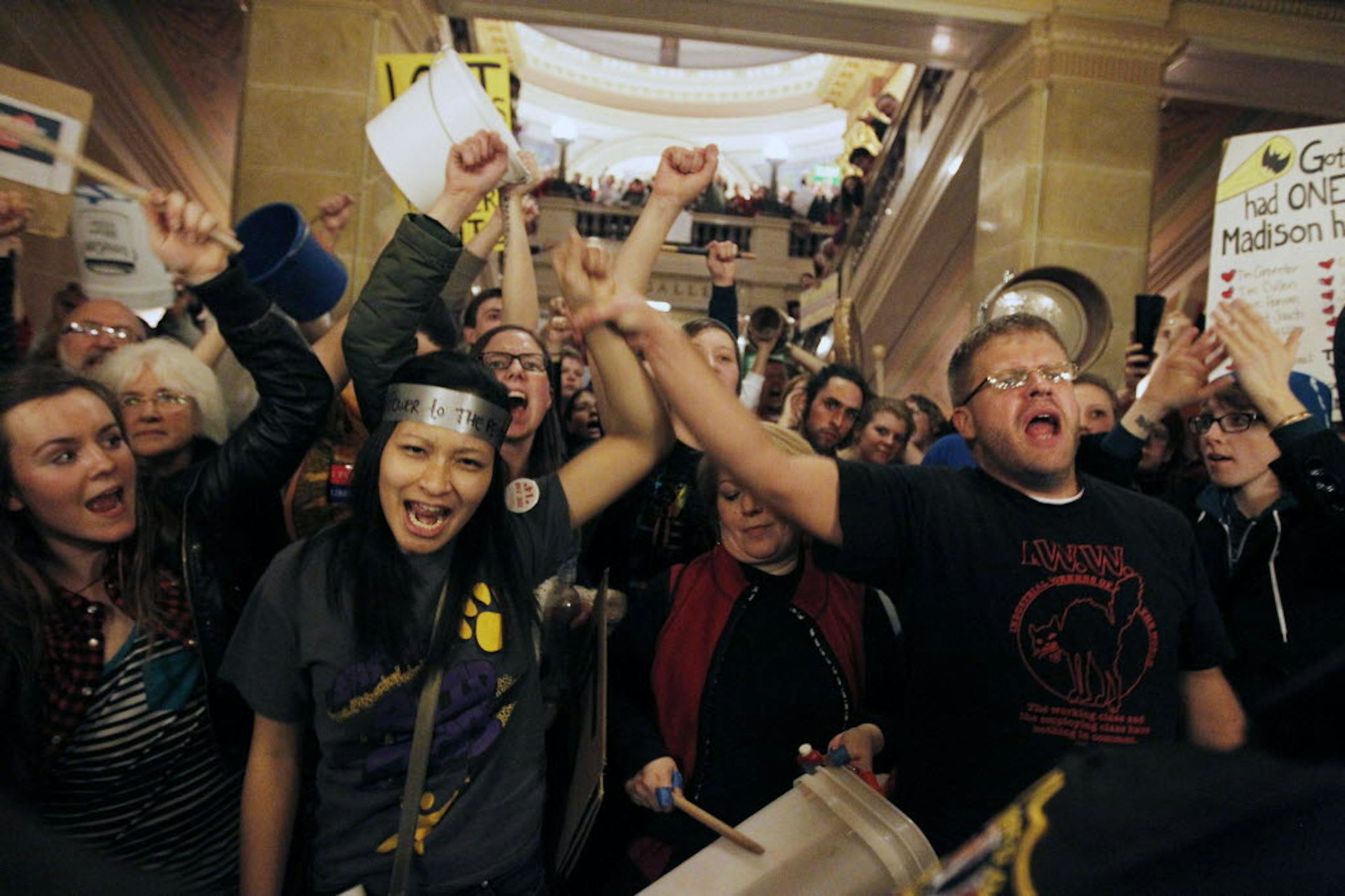 As protests entered another day at the State Capitol in Wisconsin, demonstrators crowded in an area outside Gov. Scott Walker's offices, but were held at bay by police.