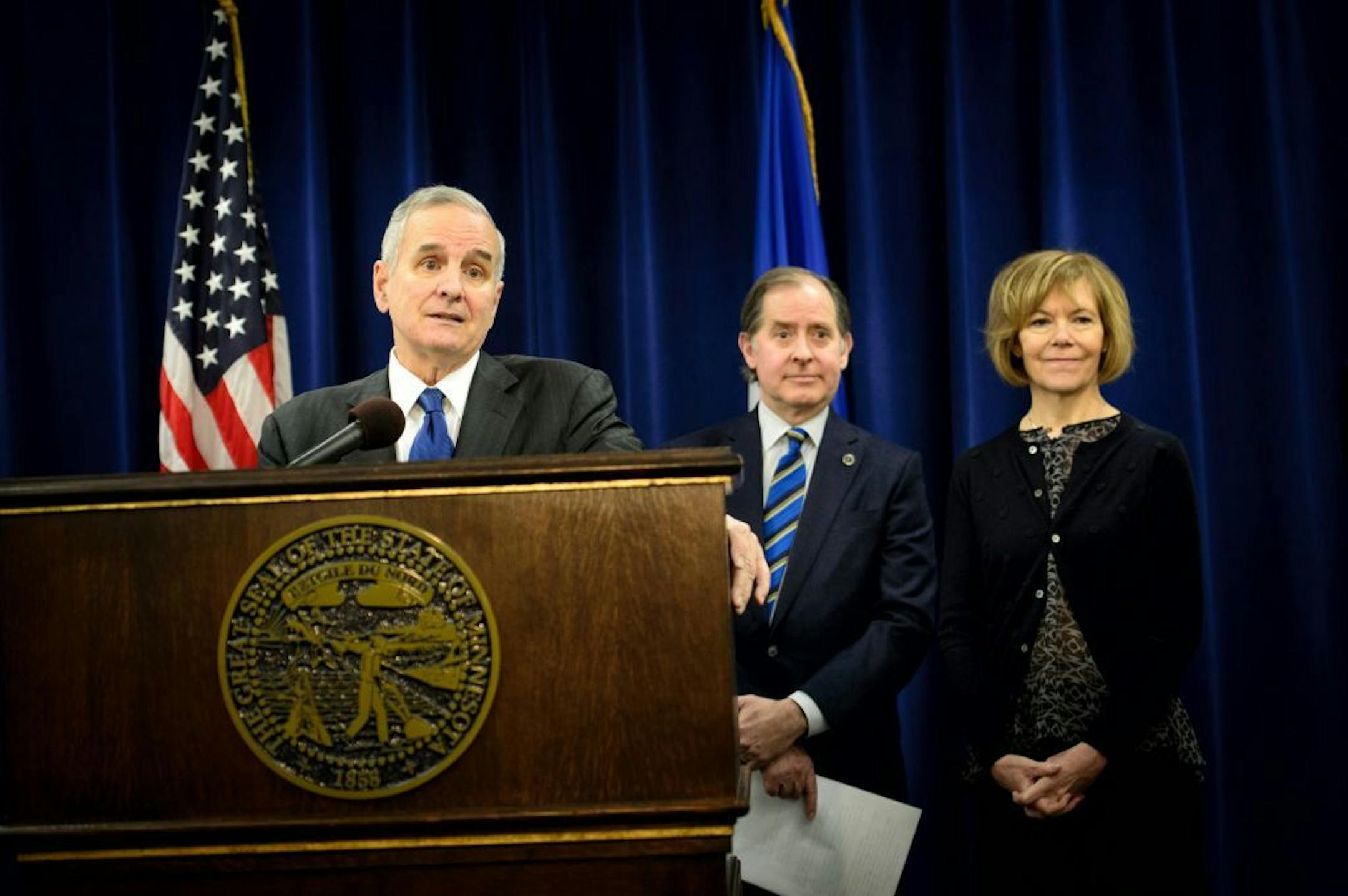 Governor Mark Dayton explained his plan to fix Minnesota's transportation systems at a press conference today. Behind him are Transportation commissioner Charles Zelle, Lt Governor Tina Smith.
