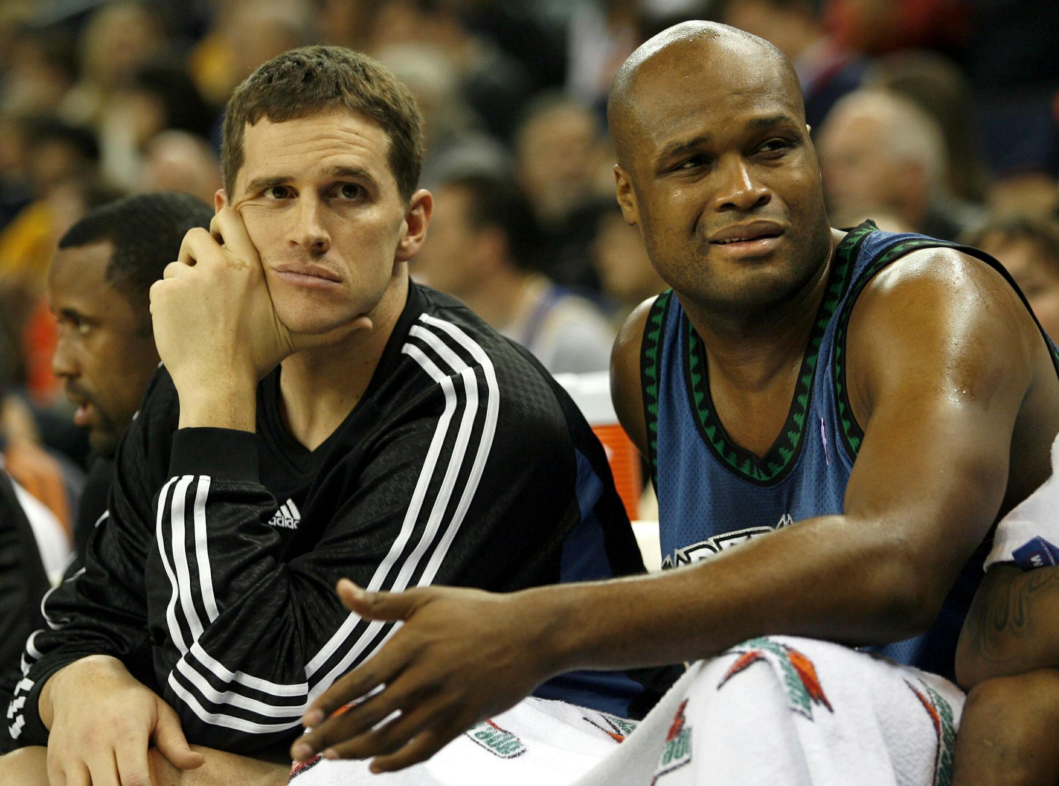 Minnesota Timberwolves' Mark Madsen, left, and Antoine Walker, right, watch their team from the bench.