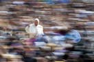 Pope Francis waves to the crowd as he arrives on his pope-mobile for his weekly general audience, in St. Peter's Square at the Vatican, Wednesday, Apr