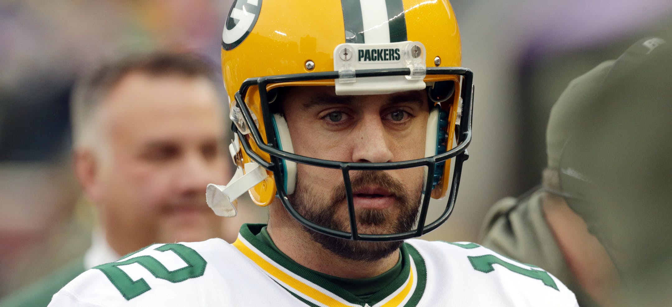 Green Bay Packers quarterback Aaron Rodgers talks with a coach during the second half of an NFL football game against the Minnesota Vikings, Sunday, Nov. 23, 2014, in Minneapolis. (AP Photo/Jim Mone)