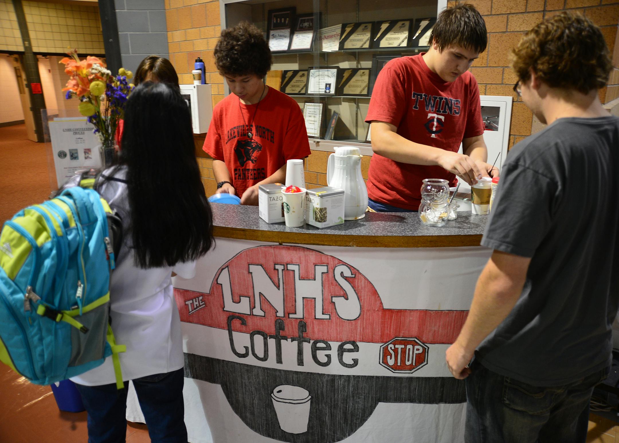Lakeville North High School is creating a new cyber cafe, featuring Starbucks products, serving coffee, tea and other basic drinks. They're remodeling an area near the cafeteria to accommodate it and added outlets and seating. Michael Eacheco on the left and Lucas Ince worked behind the counter serving coffee to students and faculty before school.] Richard.Sennott@startribune.com Richard Sennott/Star Tribune Lakeville Minnesota Wednesday 9/17/13) ** (cq)