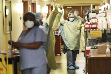 Healthcare workers don PPE at Bethesda Hospital in St. Paul.