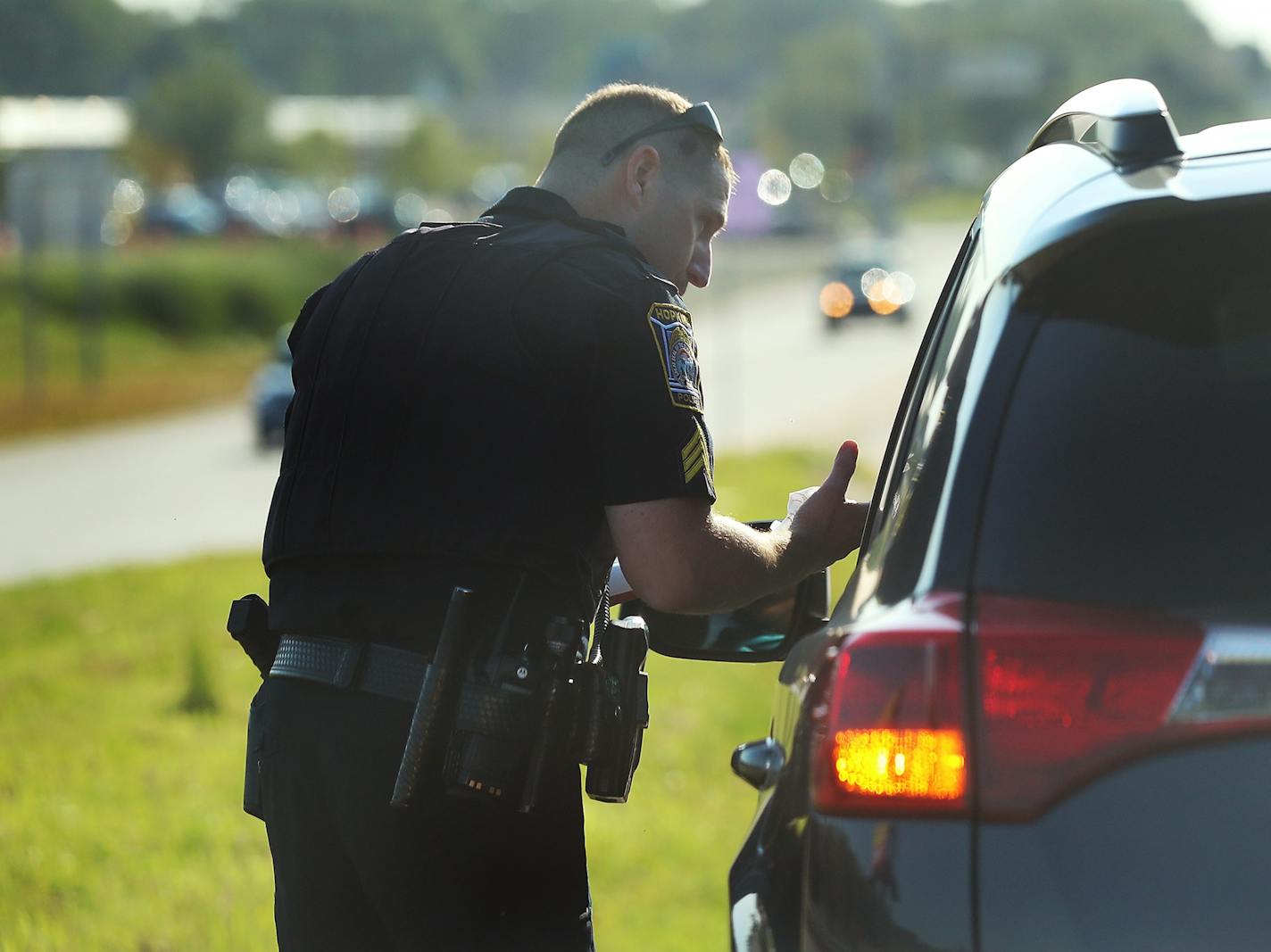 Hopkins police officer Sgt. Mike Glassberg was out patrolling Hopkins roads looking for violators on the first day of the new hands free law Thursday, Aug. 1, 2019, in Hopkins, MN. Here, Sgt. Glassberg prepared to issue a ticket to a driver that had been holding a cell phone near Highway 7 and Blake Rd.