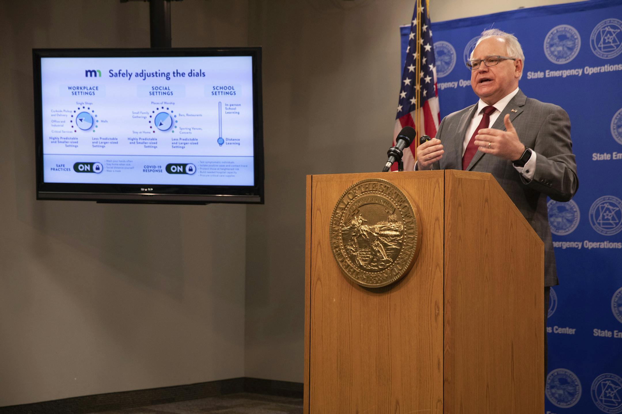 Minnesota Gov. Tim Walz speaks at a news conference inside the Department of Public Safety in St. Paul, Minn., on Thursday, April 30, 2020. Walz unveiled a plan that extends the state's stay-at-home order and keeps bars and restaurants takeout-only until May 18, but also makes changes to allow some additional business operations. (Evan Frost/Minnesota Public Radio via AP, Pool)