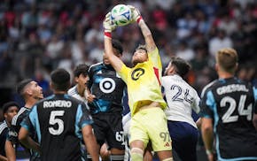 Loons goalkeeper Dayne St. Clair (97) grabs the ball away from Vancouver's Brian White (24) during the second half of Wednesday's 0-0 draw.