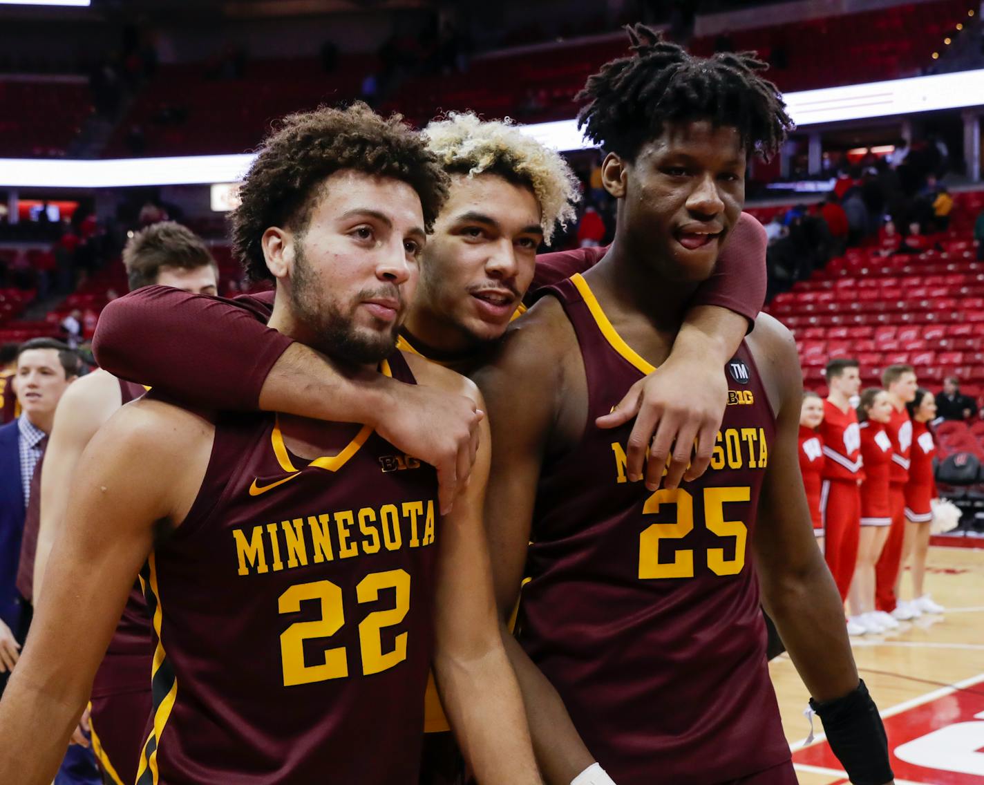 Minnesota's Gabe Kalscheur (22), Jarvis Omersa and Daniel Oturu (25)