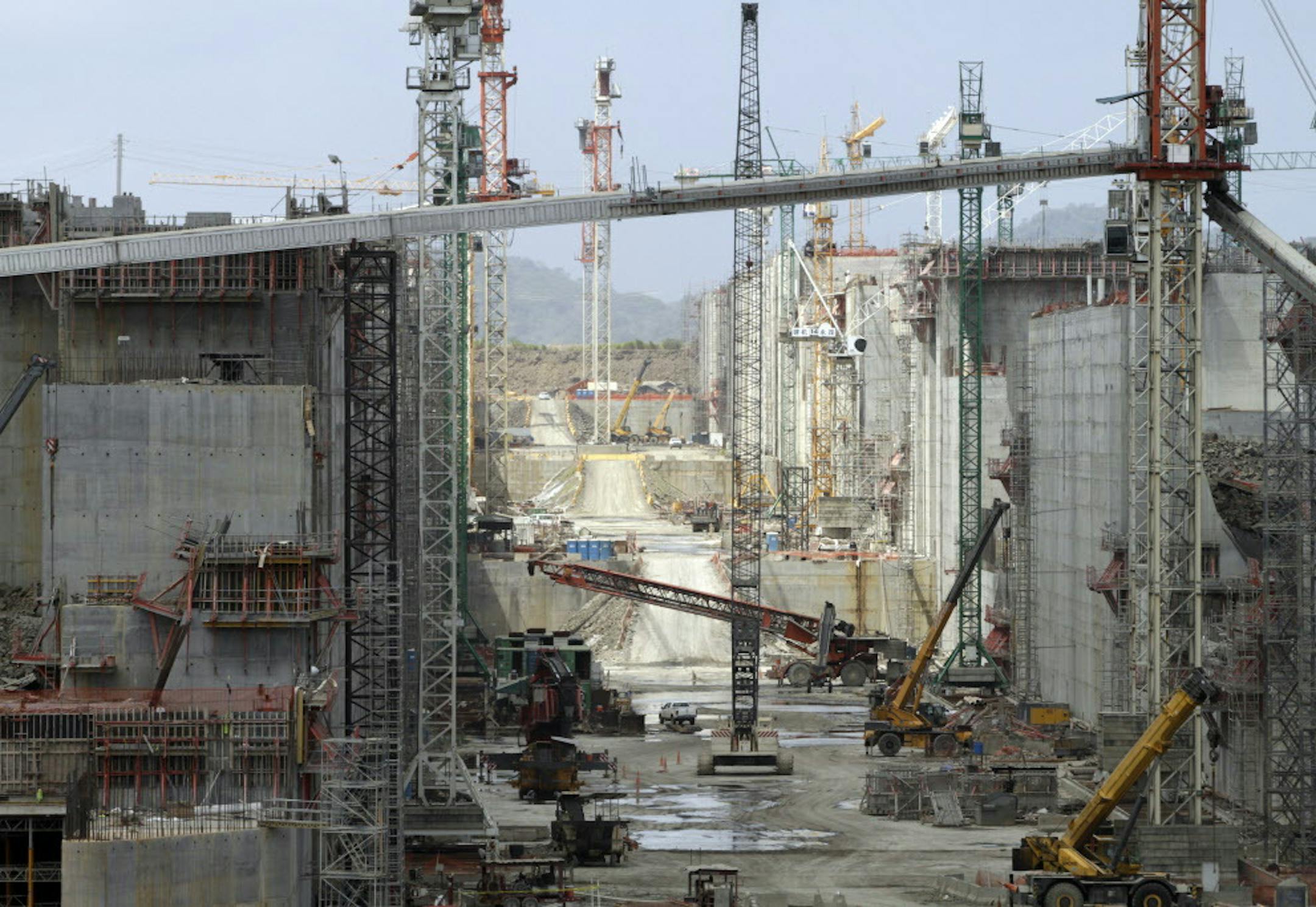 Machinery and cranes tower over the construction site of the Panama Canal's expansion project in Cocoli, Panama City, Wednesday, Feb. 5, 2014. Work on the ambitious Panama Canal expansion project was halted Wednesday after talks broke down on how to settle a dispute over $1.6 billion in cost overruns. Panama Canal Authority Administrator Jorge Quijano told a news conference the stoppage will give authorities time to analyze how to proceed on the project to widen the canal. (AP Photo/Arnulfo Fran