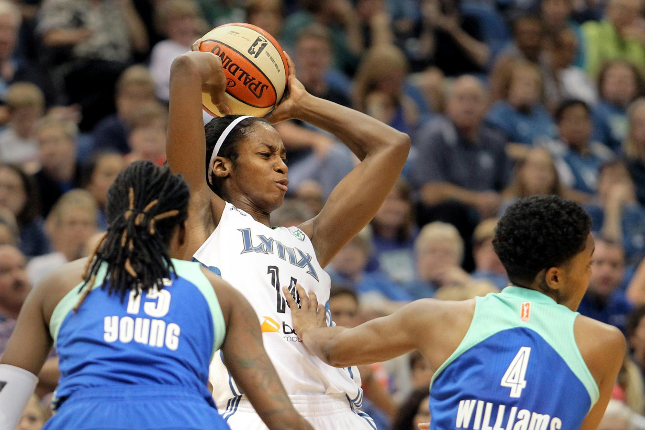 Minnesota's Devereaux Peters (14) looks to pass against the defense of New York's Toni Young (15) and Kamiko Williams (4) in the second half of the New York Liberty vs. Minnesota Lynx basketball game at Target Center on Sunday, August 18, 2013. The Lynx won the game 88-57.