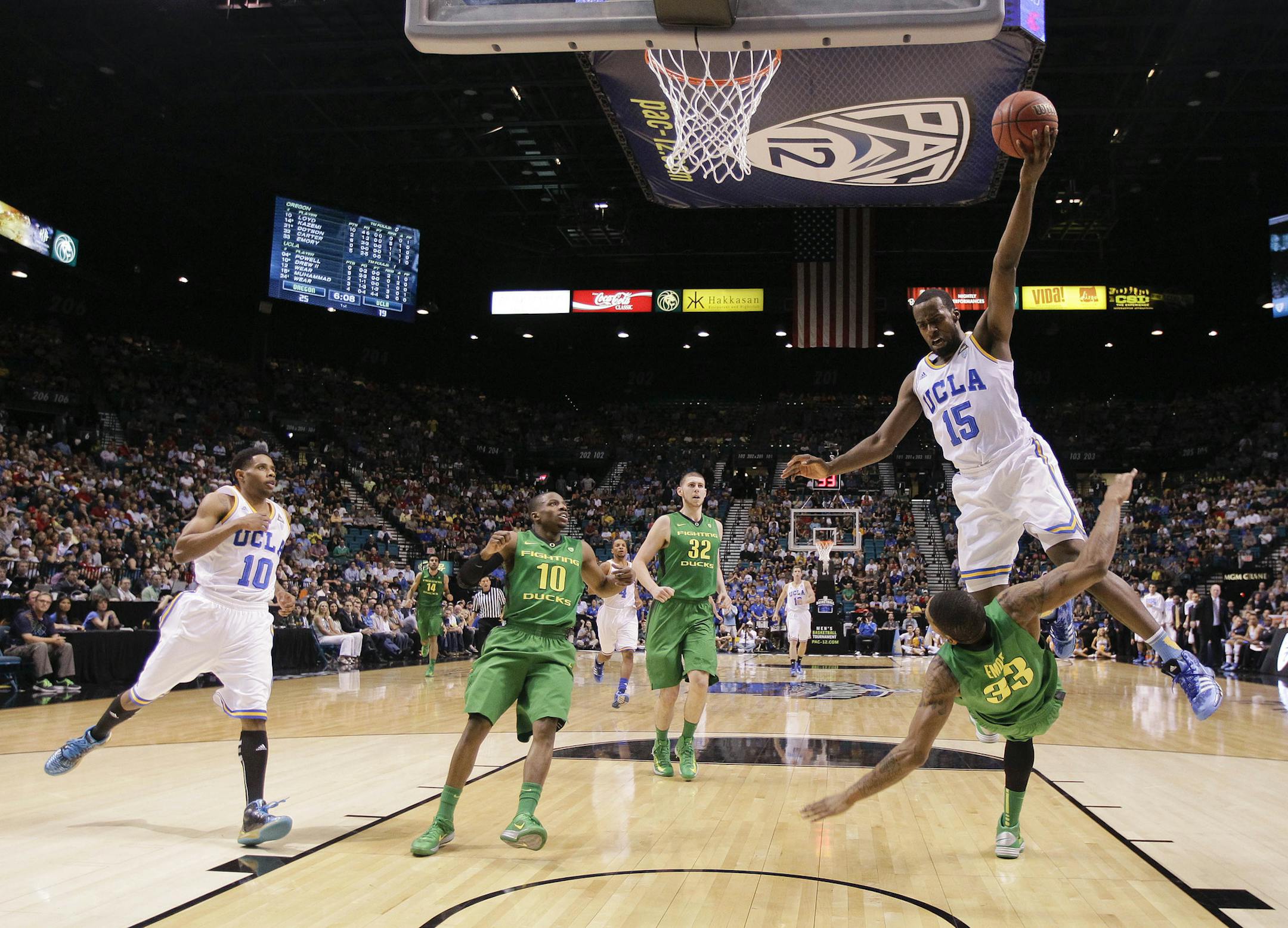 UCLA's Shabazz Muhammad collides with Oregon's Carlos Emory as he drives in for a basket in the first half of their NCAA college basketball game in the Pac-12 Conference tournament, Saturday, March 16, 2013, in Las Vegas. Muhammad was charged with an offensive foul on the play, and the UCLA bench was charged with a technical foul. (AP Photo/Julie Jacobson)