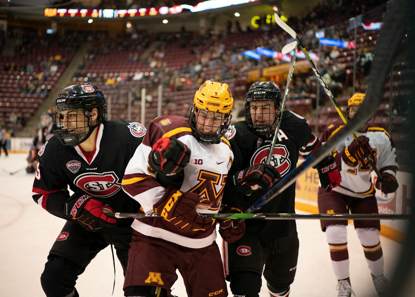 Minnesota Golden Gophers forward Sammy Walker (9) was kept from the puck by St. Cloud State Huskies' Ondrej Trejbal, left, and forward Nick Poehling in the first period. ] JEFF WHEELER • Jeff.Wheeler@startribune.com