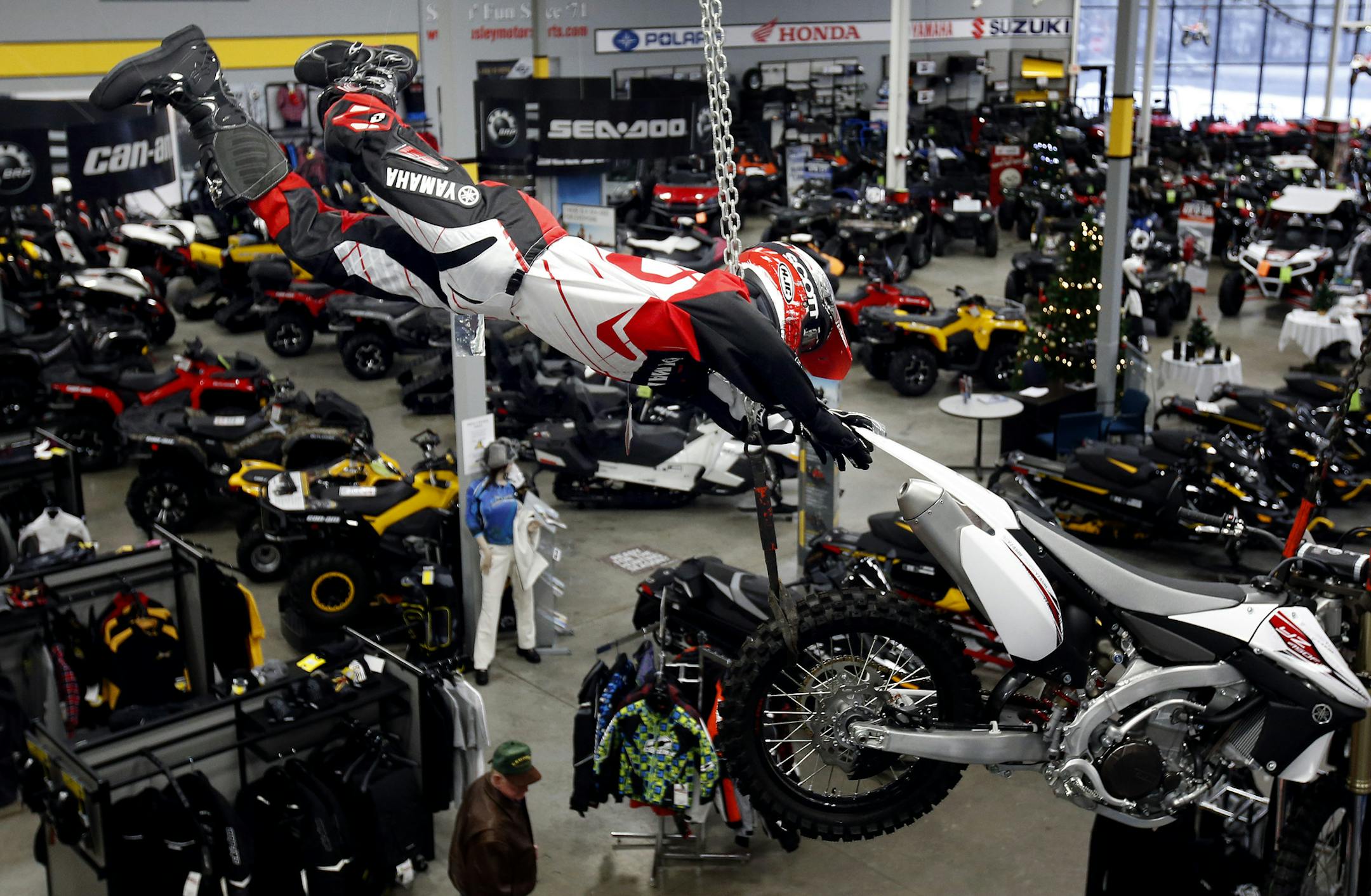 A jumping motorcycle rider was on display over the showroom floor at Tousley Motorsports in Vadnais Heights. ] CARLOS GONZALEZ cgonzalez@startribune.com - December 16, 2013, Vadnais Heights, MN, Tousley Motorsports, Youth snowmobiles and ATVs are going to be tucked under the Christmas tree this year thanks to a pick up in sales at Polaris and Arctic Cat dealerships