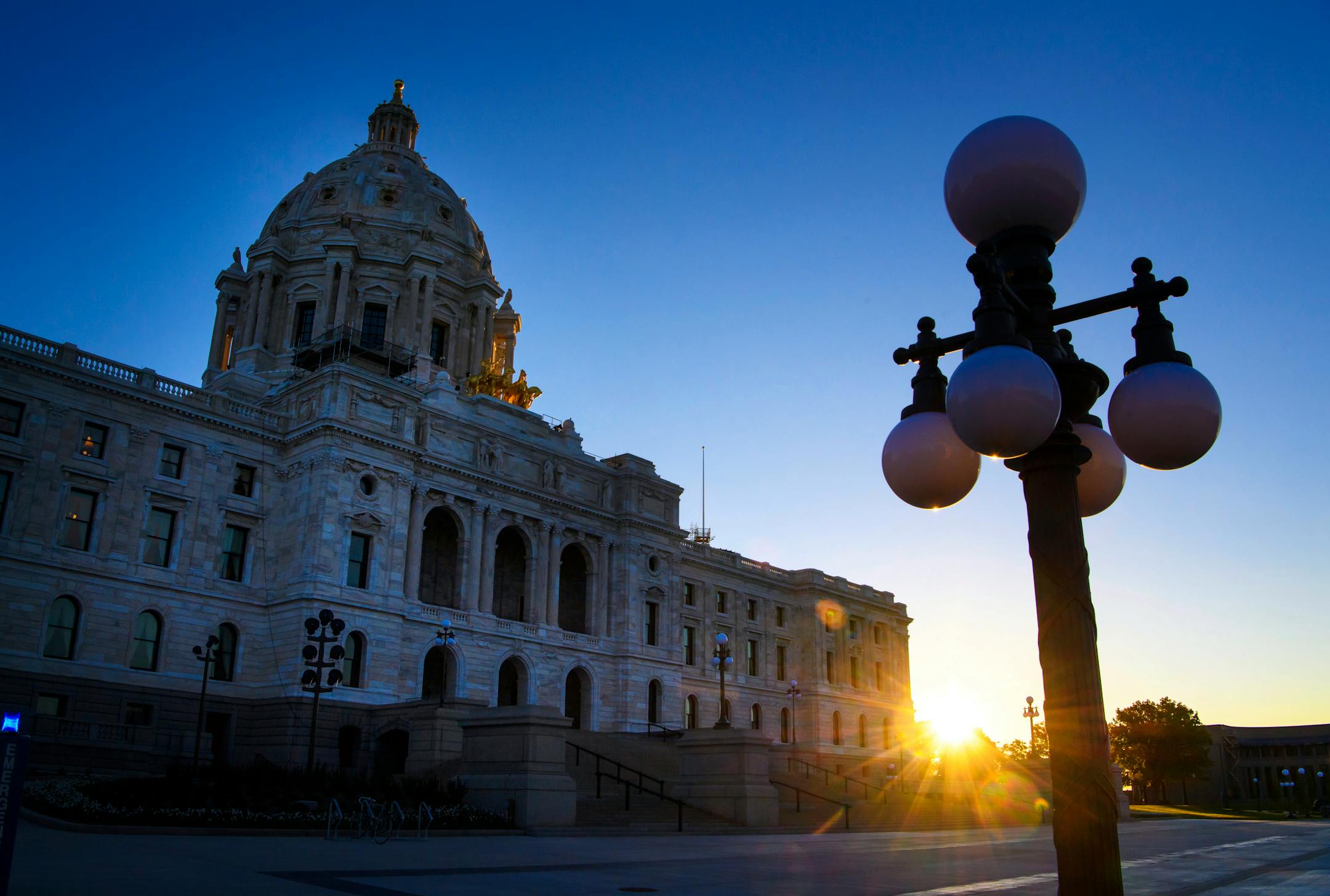 The sun rises behind the Minnesota State Capitol as lawmakers continued their work inside on Wednesday, May 24, 2017 in St. Paul, Minn. The Minnesota Legislature blew past a self-imposed 7 a.m. Wednesday deadline to finish work on a $46 billion budget. The House had several major votes remaining, and the Senate hadn�t taken any votes overnight as hope evaporated for a tidy wrapup to the five-month session. (Glen Stubbe/Star Tribune via AP)
