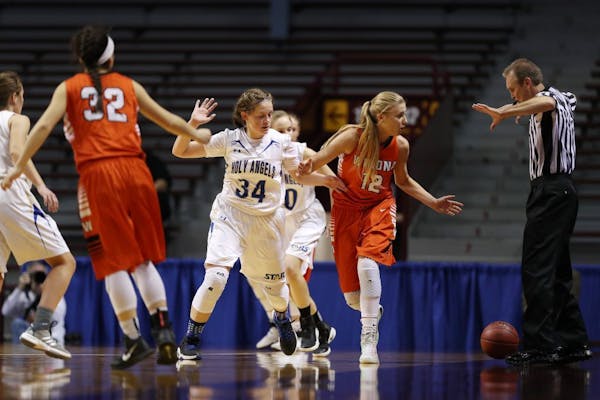 Players looked on as an official made an out-of-bounds call during the 2017 state girls' basketball tournament.