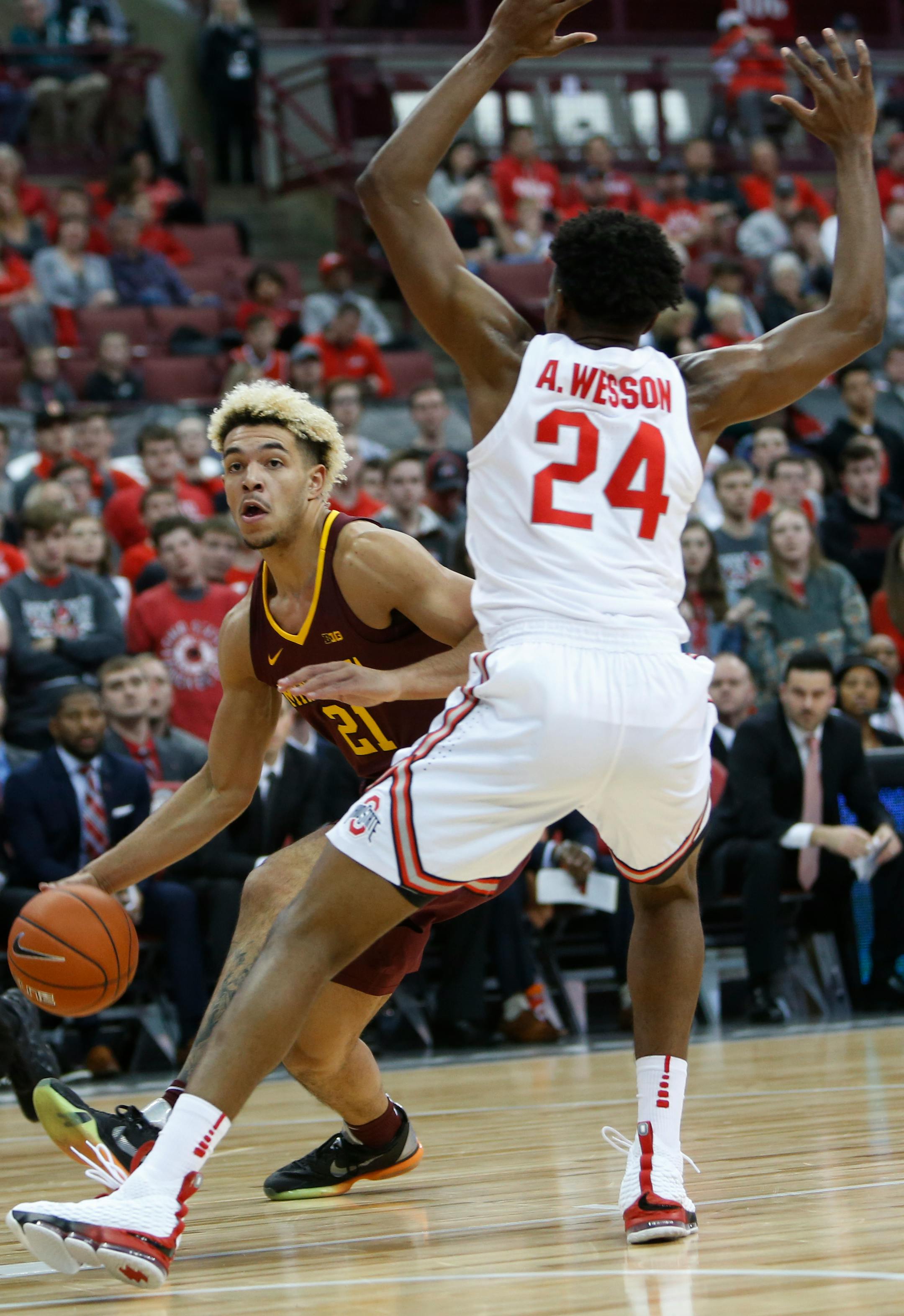 Minnesota's Jarvis Omersa, left, drives to the basket against Ohio State's Andre Wesson during the first half of an NCAA college basketball game Sunday, Dec. 2, 2018, in Columbus, Ohio. (AP Photo/Jay LaPrete)