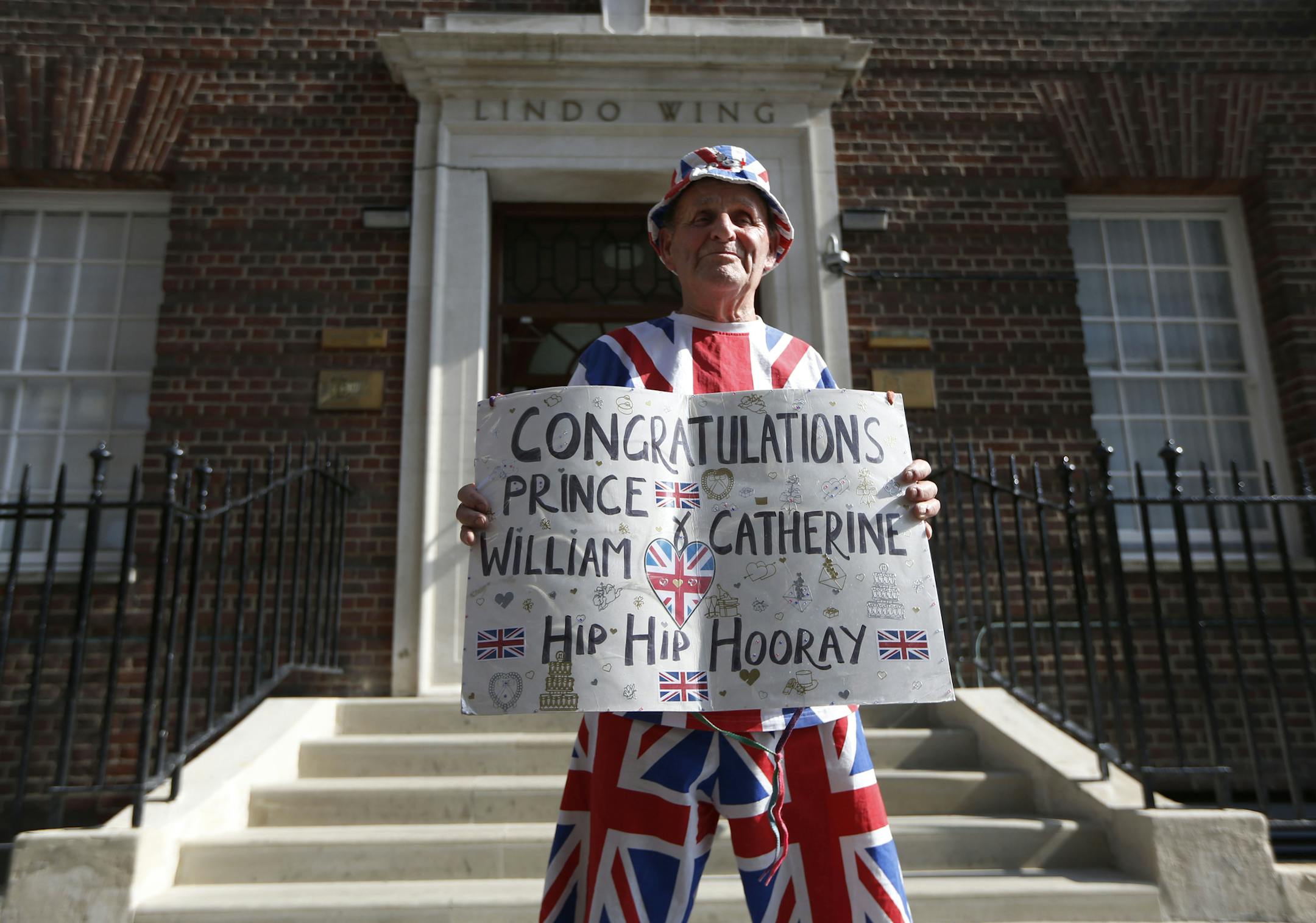 Royal supporter Terry Hutt poses outside St. Mary's Hospital Lindo Wing in London as he arrives to stake his place outside the building where Prince William and his wife Kate are expecting their first child to be born in mid-July, Wednesday, July 10, 2013. (AP Photo/Sang Tan)