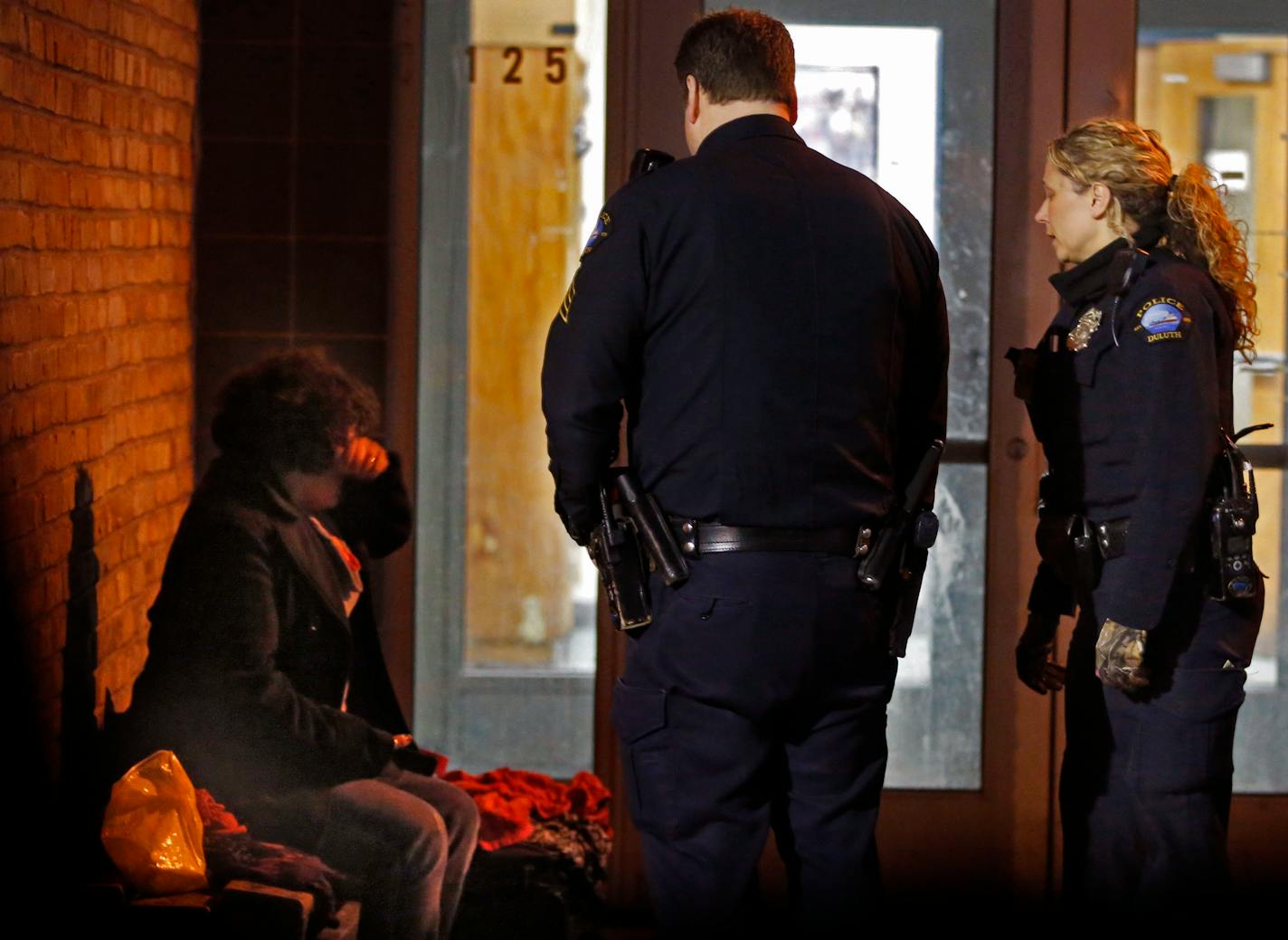 A woman who is medicated for mental health issues but hasn't finished drug treatment is kicked out of CHUM, Duluth's only homeless shelter, for disrupting the other clients. Officer Angela Robertson, far right, went out of her way to get her a bed for the night.]The police department in Duluth is the first in Minnesota to use an embedded a social worker in a pilot program. Richard Tsong-Taatarii/rtsong-taatarii@startribune.com