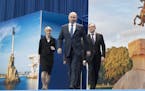 Russian President Vladimir Putin, center, arrives to attend a meeting with his supporters in Moscow, Russia, Tuesday, Jan. 30, 2018. Putin is expected