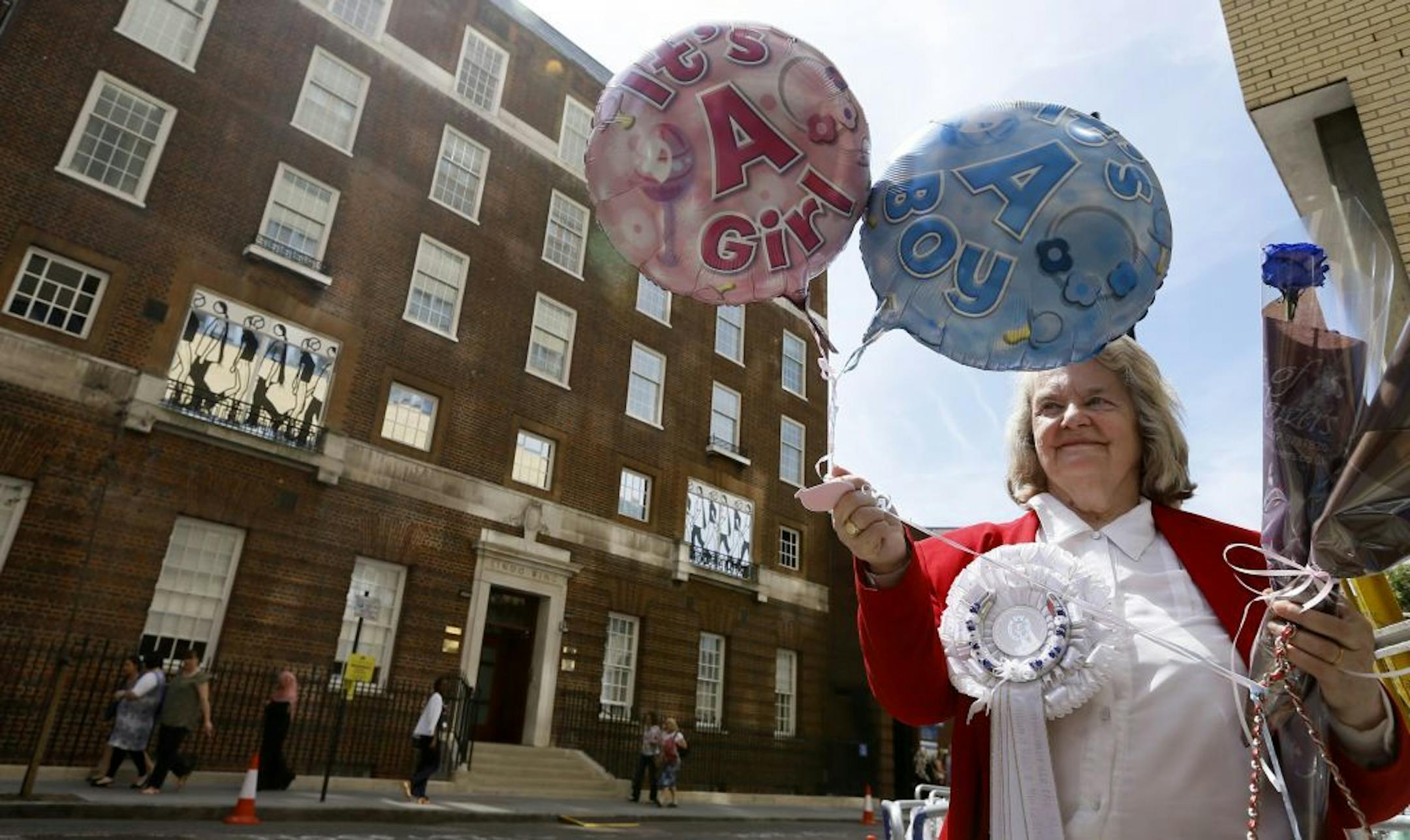 FILE - In this Monday, July 15, 2013 file photo royal supporter Margaret Tyler displays balloons for the media in front of the Lindo Wing at St Mary's Hospital in London.