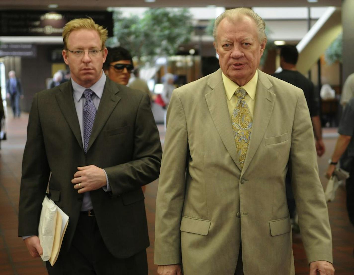 Bixby Energy Systems Inc. founder and former CEO Bob Walker, right, and Peder Davisson, former corporate counsel, walk out of Hennepin County District Court 5/10/2011after agreeing to resign from the company. The agreement settles two lawsuits over their management of the company and installs a corporate restructuing firm as the new management. The company has a coal-to-natural gas technology, and eager customers in China, but court papers allege the company is insolvent, has been grossly misman