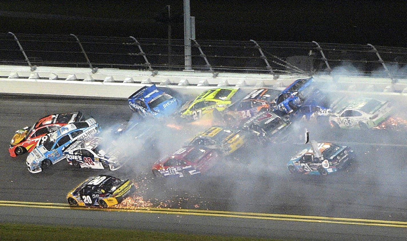 Martin Truex Jr. (78), Greg Biffle (16), Jimmie Johnson (48) and Jamie McMurray (1) are at the head of a multi-car accident between Turns 1 and 2 at Daytona International Speedway during a NASCAR Sprint Cup auto race, Saturday, July 2, 2016, in Daytona Beach, Fla. (AP Photo/Phelan M. Ebenhack)