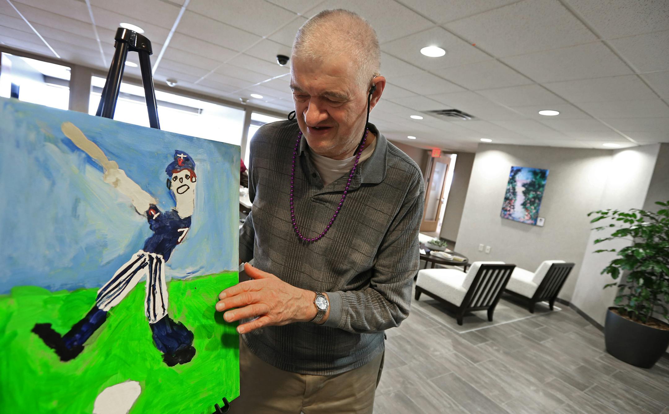 (left to right) Artist Tom Shamla stood by his painting of Joe Mauer during a meet the artist event at O'Mera Leer Wagner & Kohl law offices in Edina on 2/27/14. Edina law-firm O'Meara Leer Wagner & Kohl recently completed a smart office remodel.Their top floor offices now have clearer sight lines that allow more collaboration. The new artwork in the offices is from developmentally disabled artists. Partnership Resources, a St. Louis Park-based nonprofit, worked with the Walker Art Center helpin