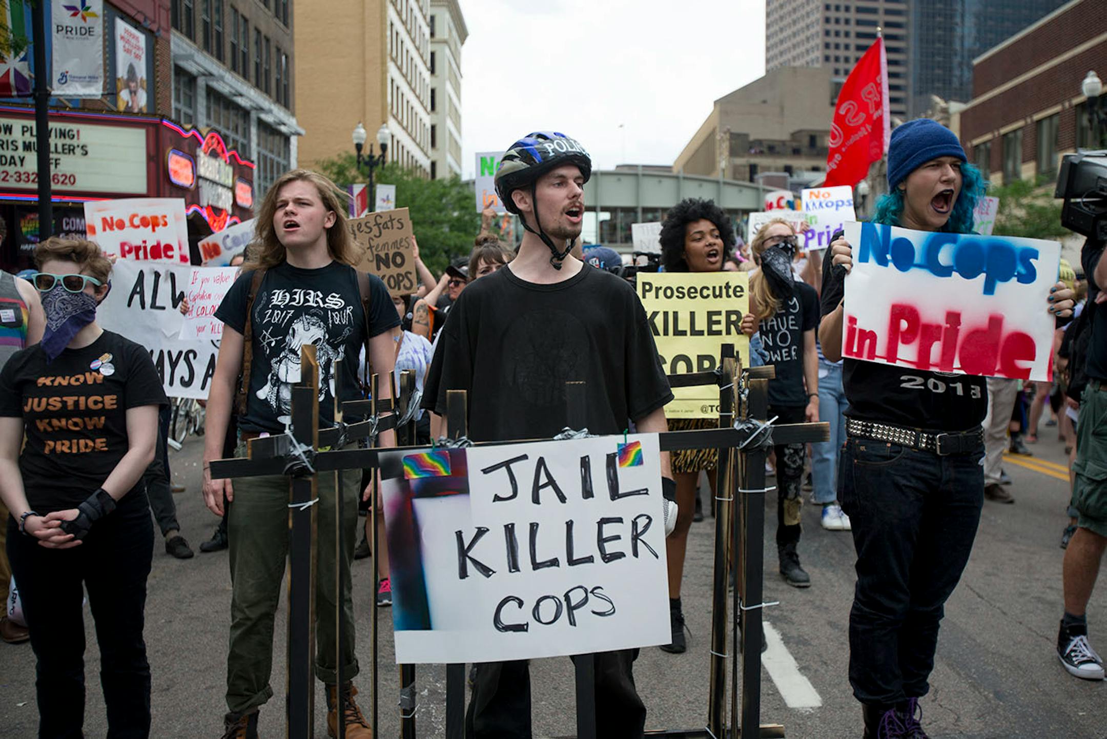 Protestors marched ahead of the pride parade on Sunday to call attention to misconduct by police and the death of black community members.