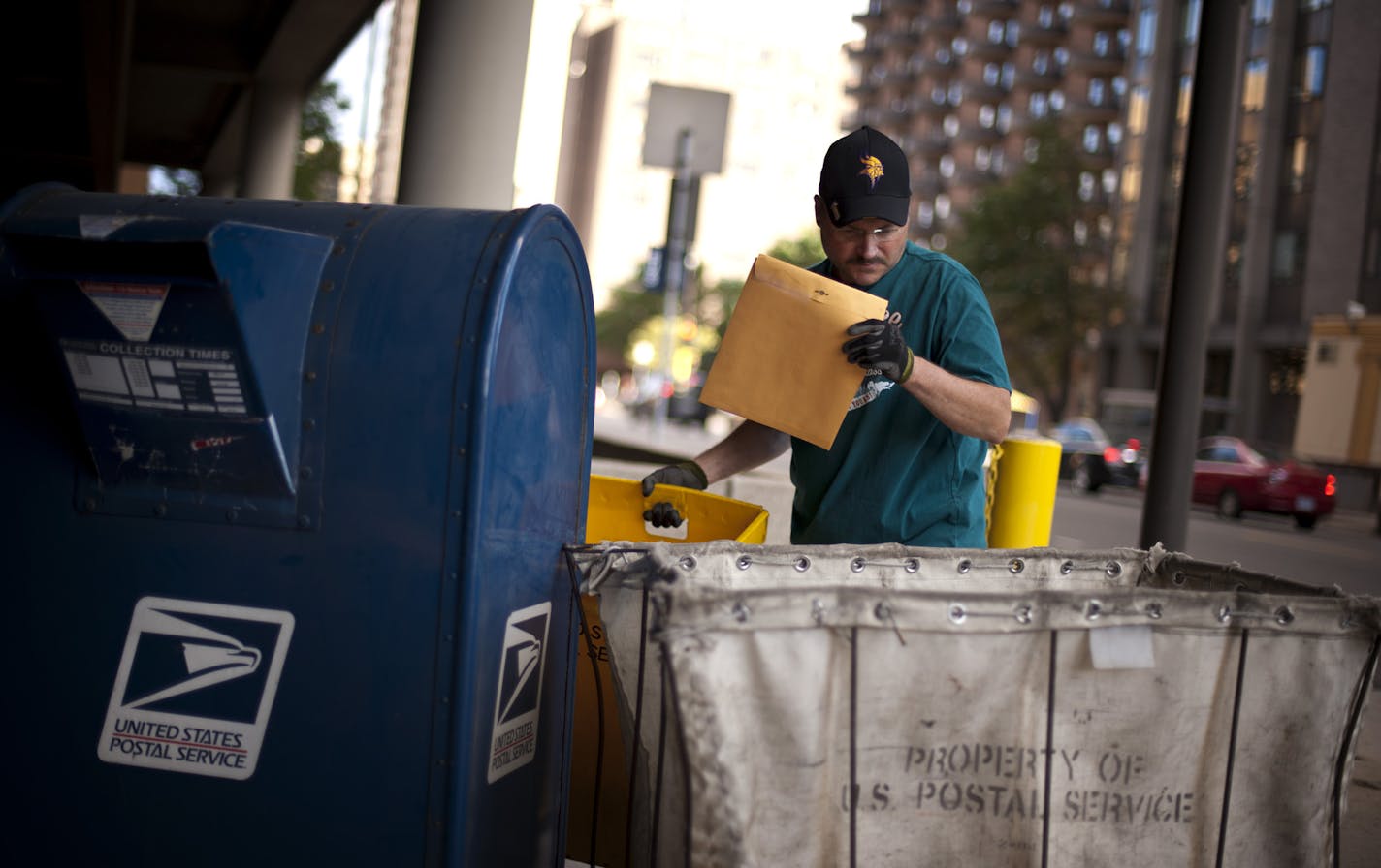 Dwight Emerson picked up mail from mailboxes in front of the downtown Minneapolis post office at the end of the day, Friday, September 7, 2012. The U.S. Postal Service is battling a long-term decline in mail volume amid changes in how people communicate. In Minnesota, US Postal Service jobs were down 4.3 percent in July from a year earlier. ] GLEN STUBBE * gstubbe@startribune.com ORG XMIT: MIN1209071753072575