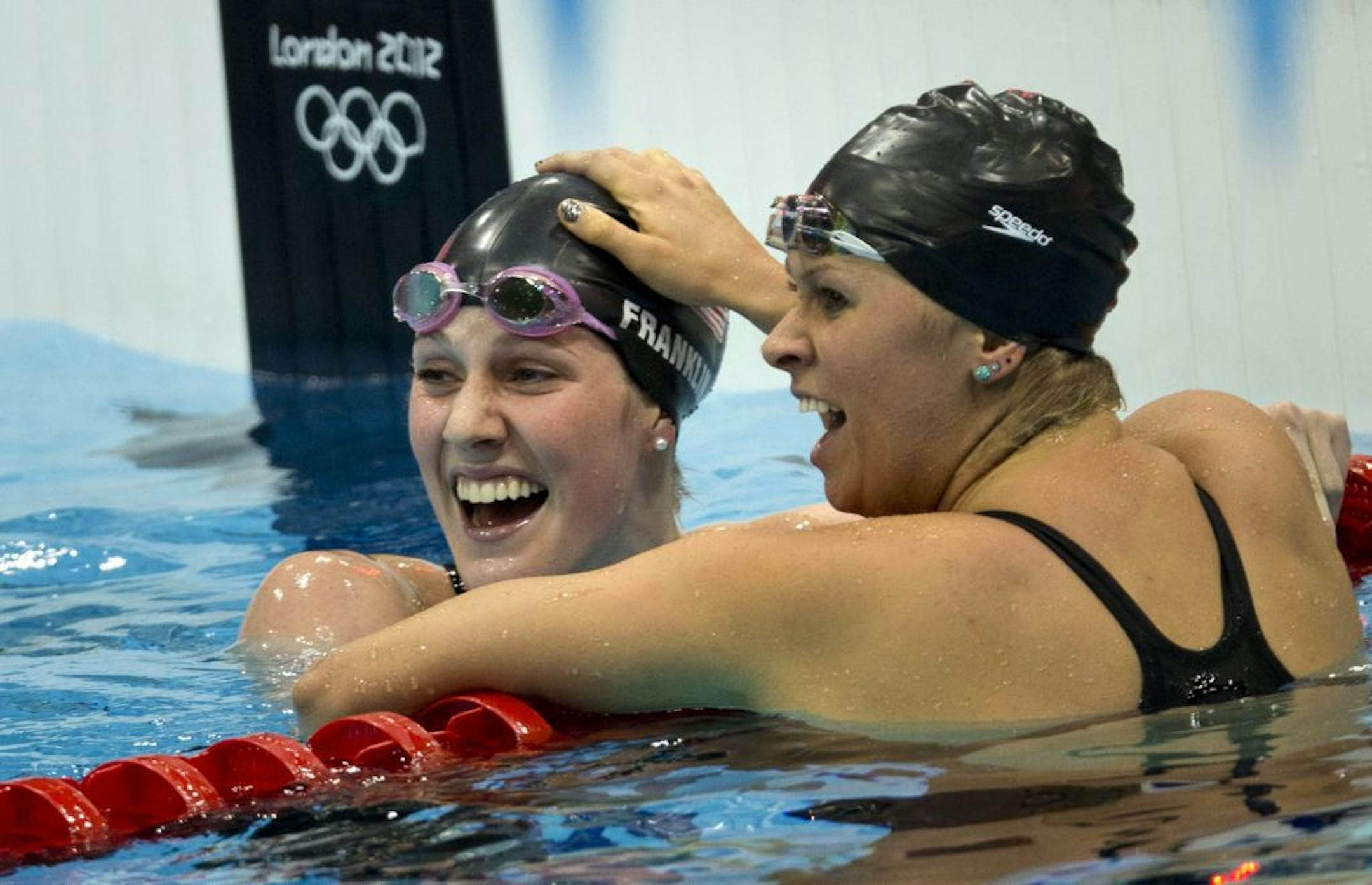 Missy Franklin, left, celebrated her Olympic gold medal in the 200-meter backstroke with teammate Elizabeth Beisel, who took the bronze. Franklin has received less attention than the U.S. gymnastics team, said Nicole LaVoi of the University of Minnesota, because gymnasts fit a more traditionally "cute" image.