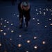 A person lights a flame during a World AIDS day event in Copenhagen, Denmark Monday Dec. 1, 2014. (AP Photo/POLFOTO/Sofia Busk) DENMARK OUT