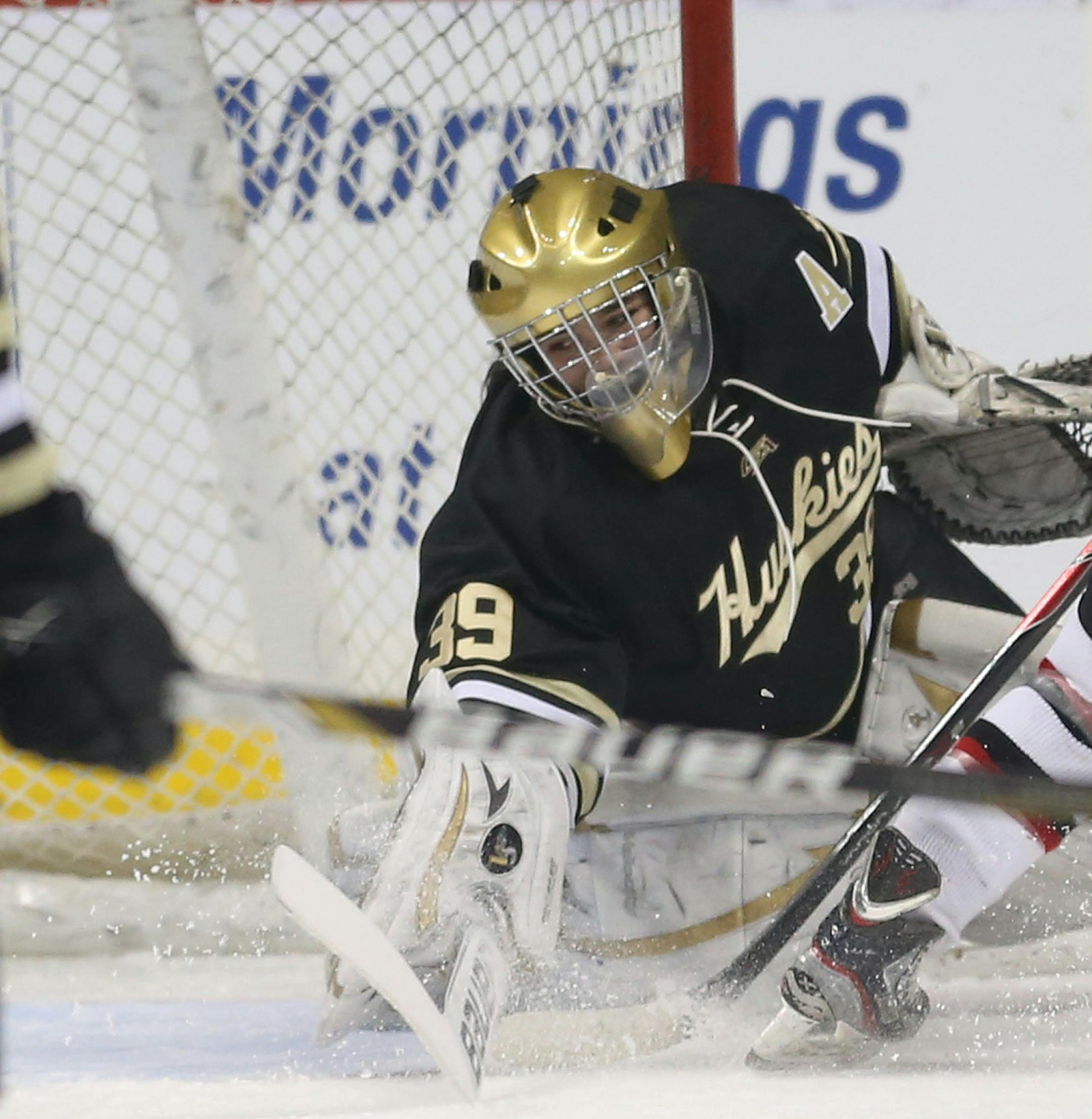 Andover's goalie Maddie Rooney dove after a puck that Eden Prairie's Crystalyn Hengler wound up scoring into the open side of the net during the second period of the 2A quarterfinals at Xcel Energy Center in St. Paul Thursday, February 20, 2014. Eden Prairie won over Andover 4-2. ] (KYNDELL HARKNESS/STAR TRIBUNE) kyndell.harkness@startribune.com